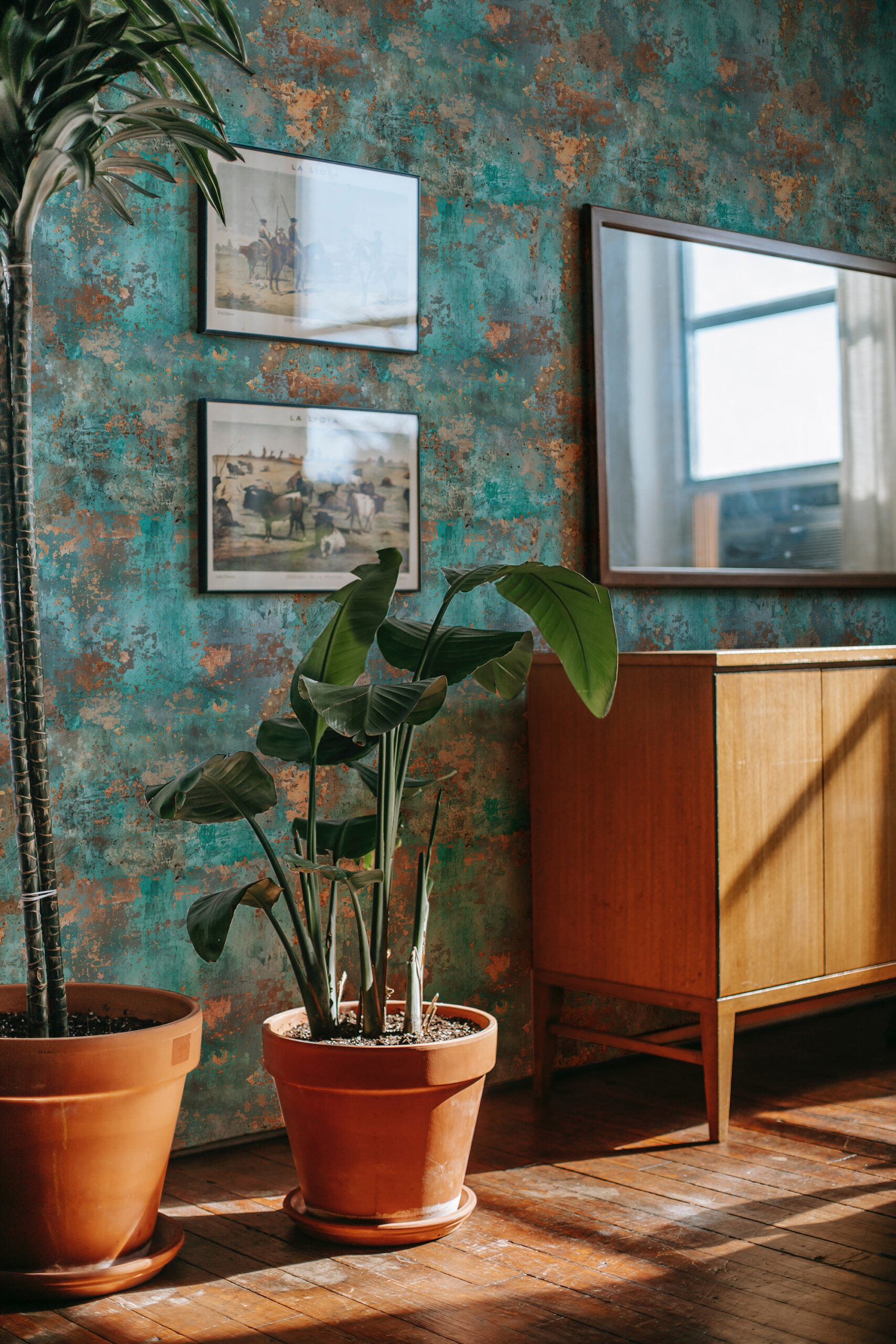 Turquoise Faux Texture self-adhesive wallpaper with a mottled teal-and-rust finish behind framed art and a mirror.