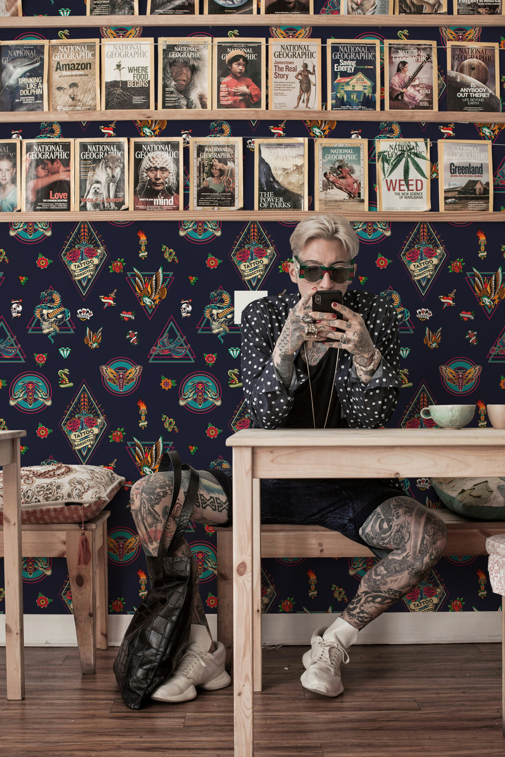 House of Tattoo Icons peel and stick wallpaper with colorful tattoo-style emblems and small icons covering the wall behind shelves.