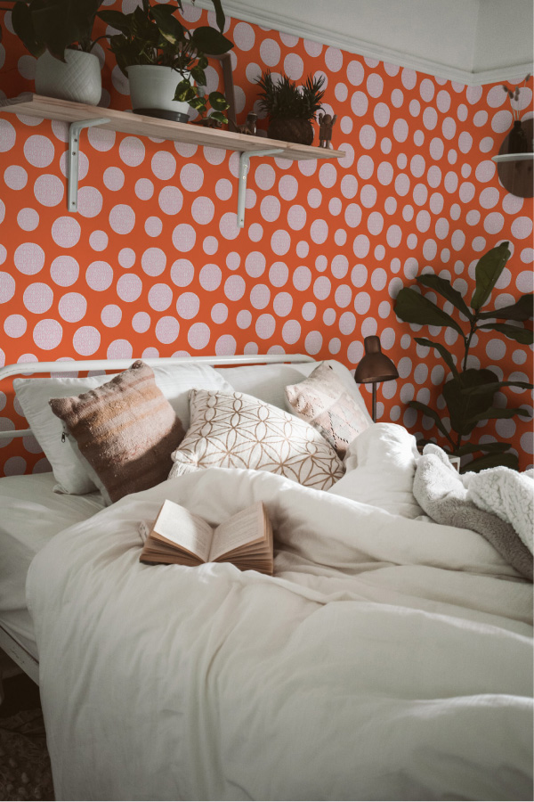 Pink and orange polka dot wallpaper in bedroom