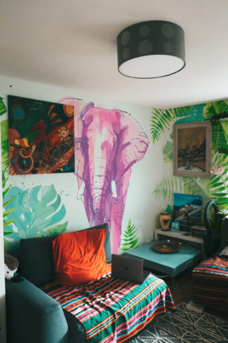 Tropical Jungle Elephant peel and stick wallpaper mural with pink sketch elephant and tropical green leaves, creating vibrant exotic jungle style, available in custom sizes