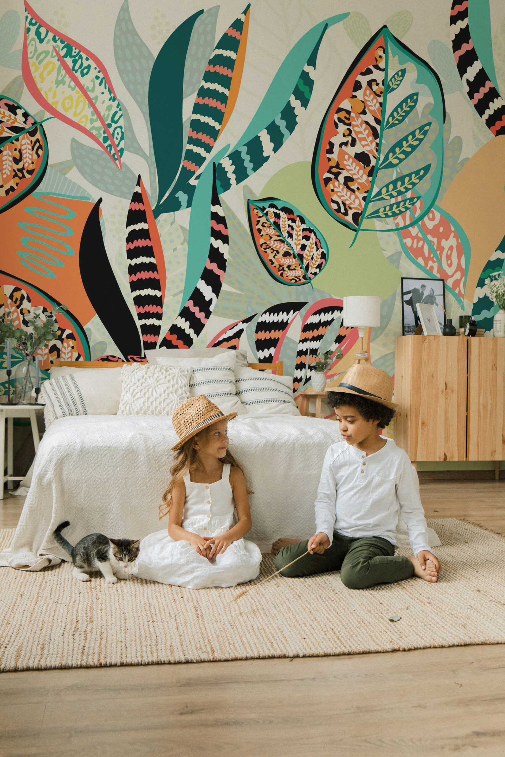 Animal Print Tropical Leaves covers the full wall as a wall mural with oversized patterned leaves in teal, coral, and black.