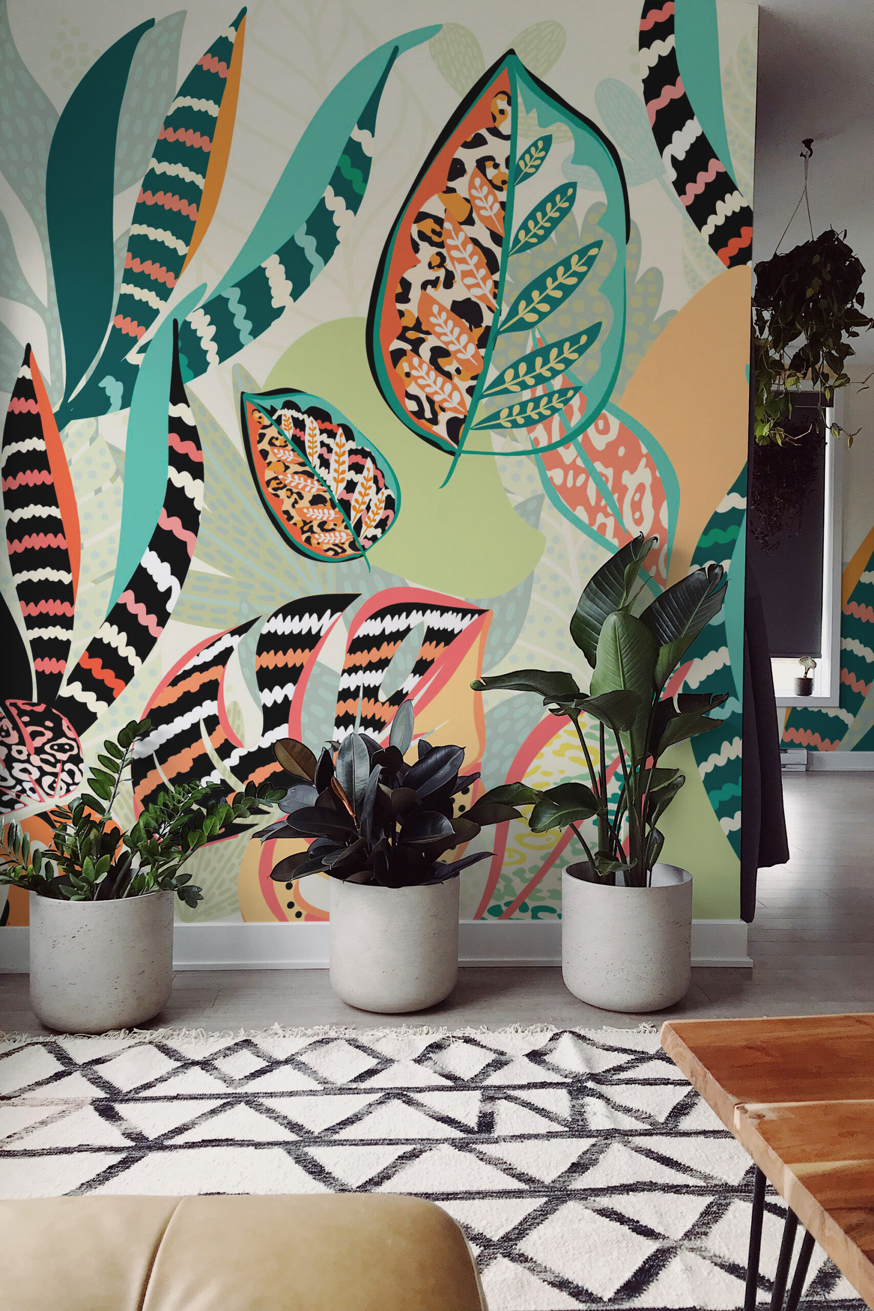 Animal Print Tropical Leaves wallpaper mural covering a full wall with bold layered leaves in teal, coral, and animal patterns.