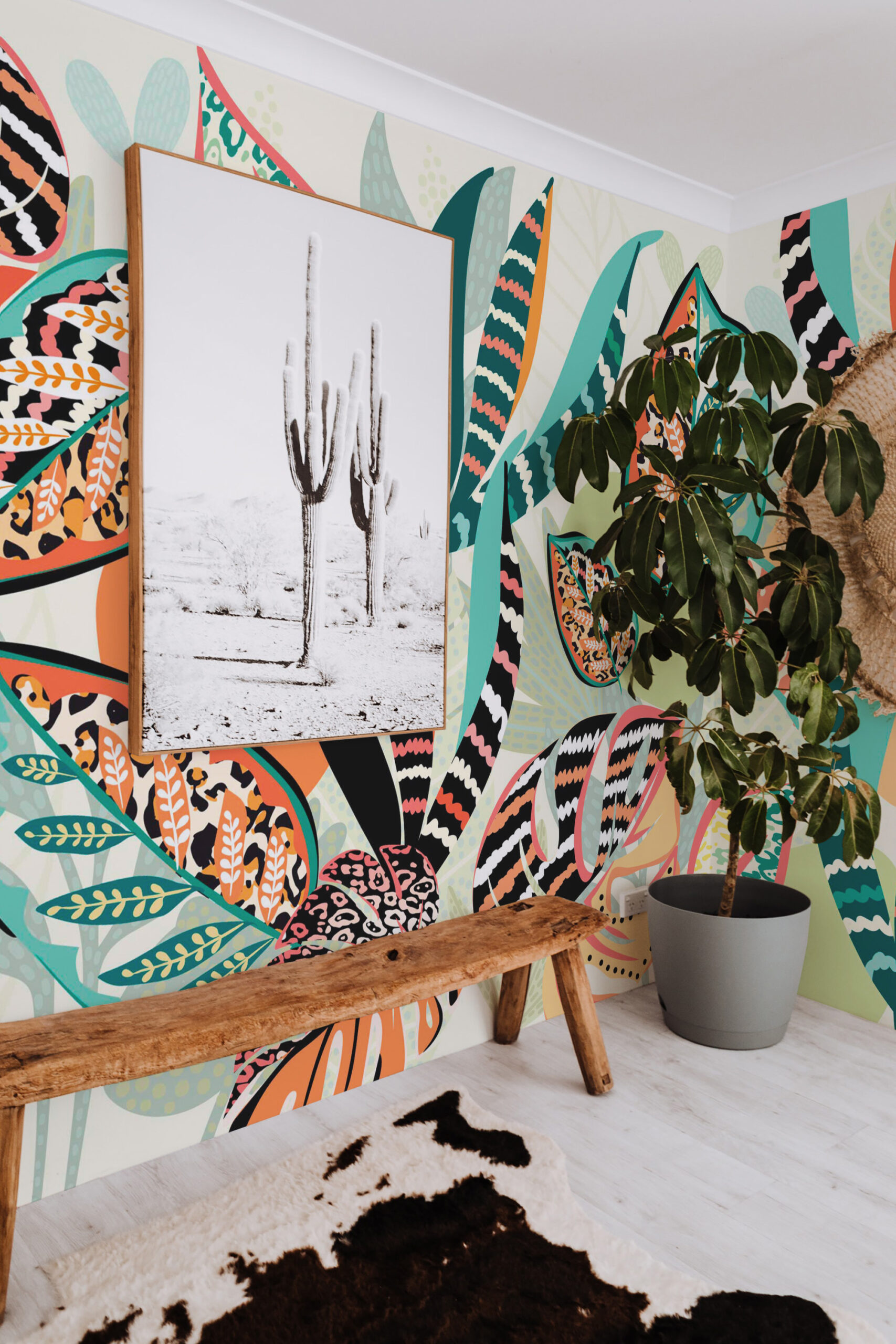 Animal Print Tropical Leaves removable wall mural wraps a corner wall with bold leafy shapes and animal stripes in teal, coral, and black.