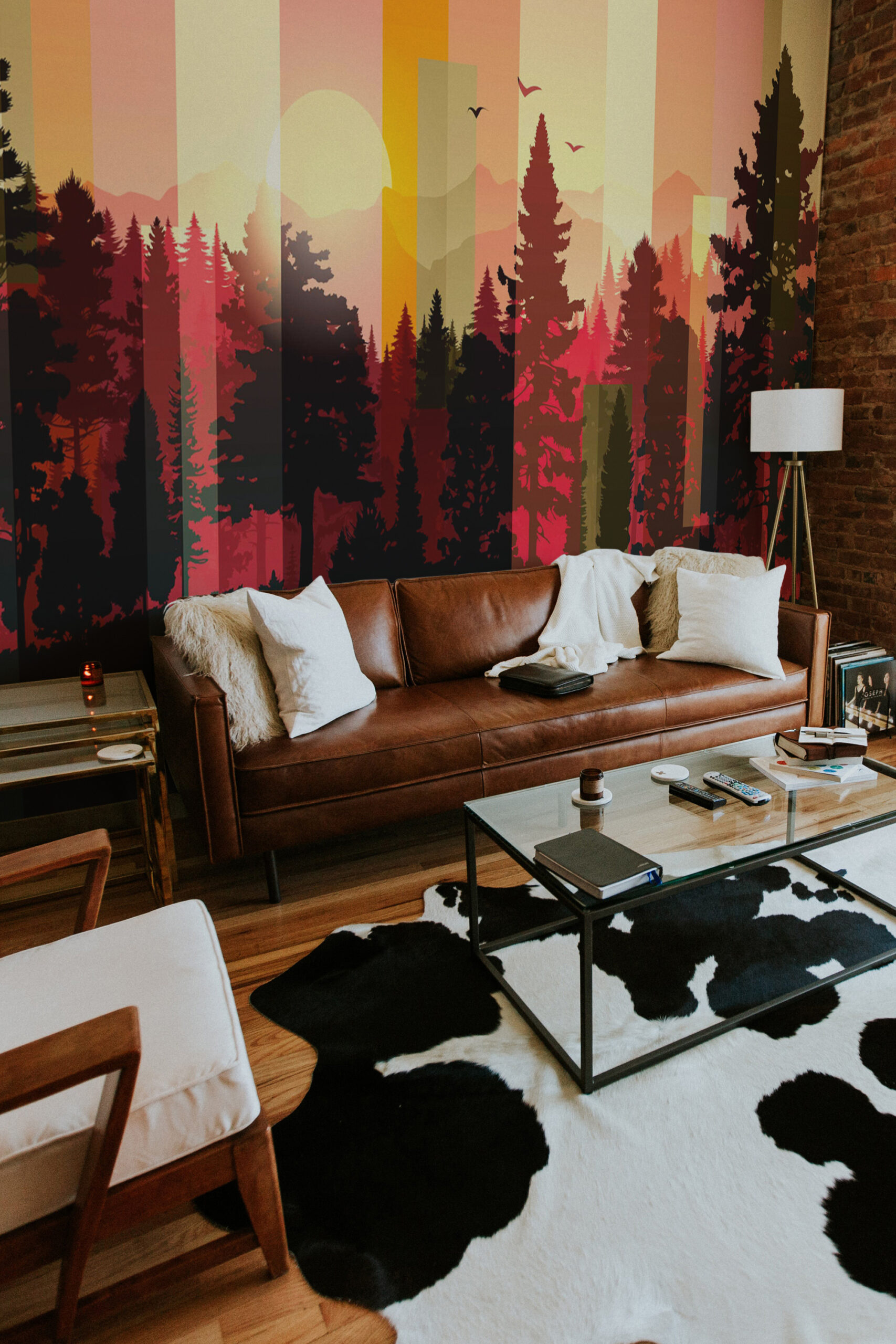 Striped Forest Sunset shows a full-wall mural of silhouetted pine trees and a warm sun behind vertical stripes.