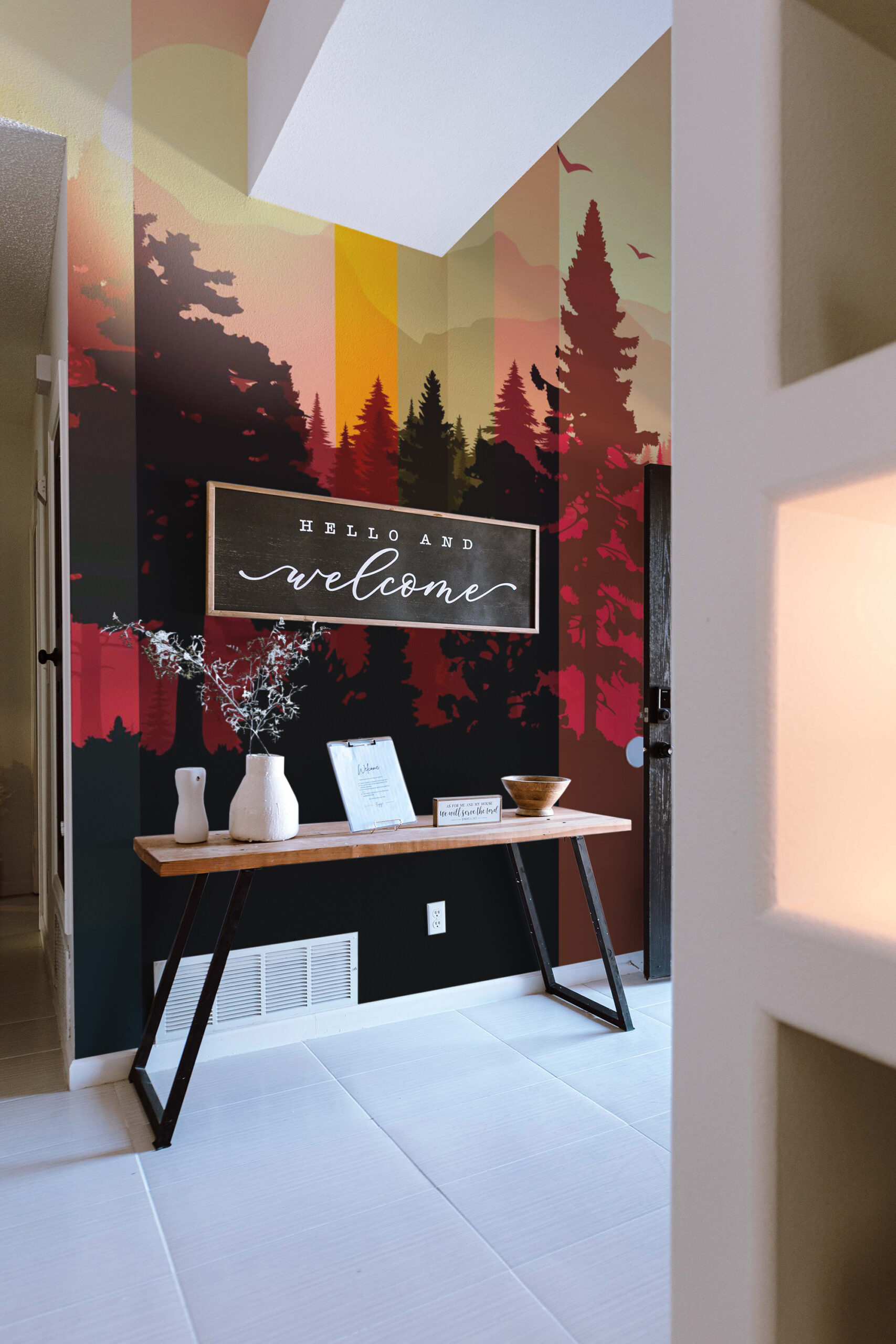 Striped Forest Sunset shows layered pine tree silhouettes and birds in a striped gradient peel and stick wallpaper mural in an entryway.