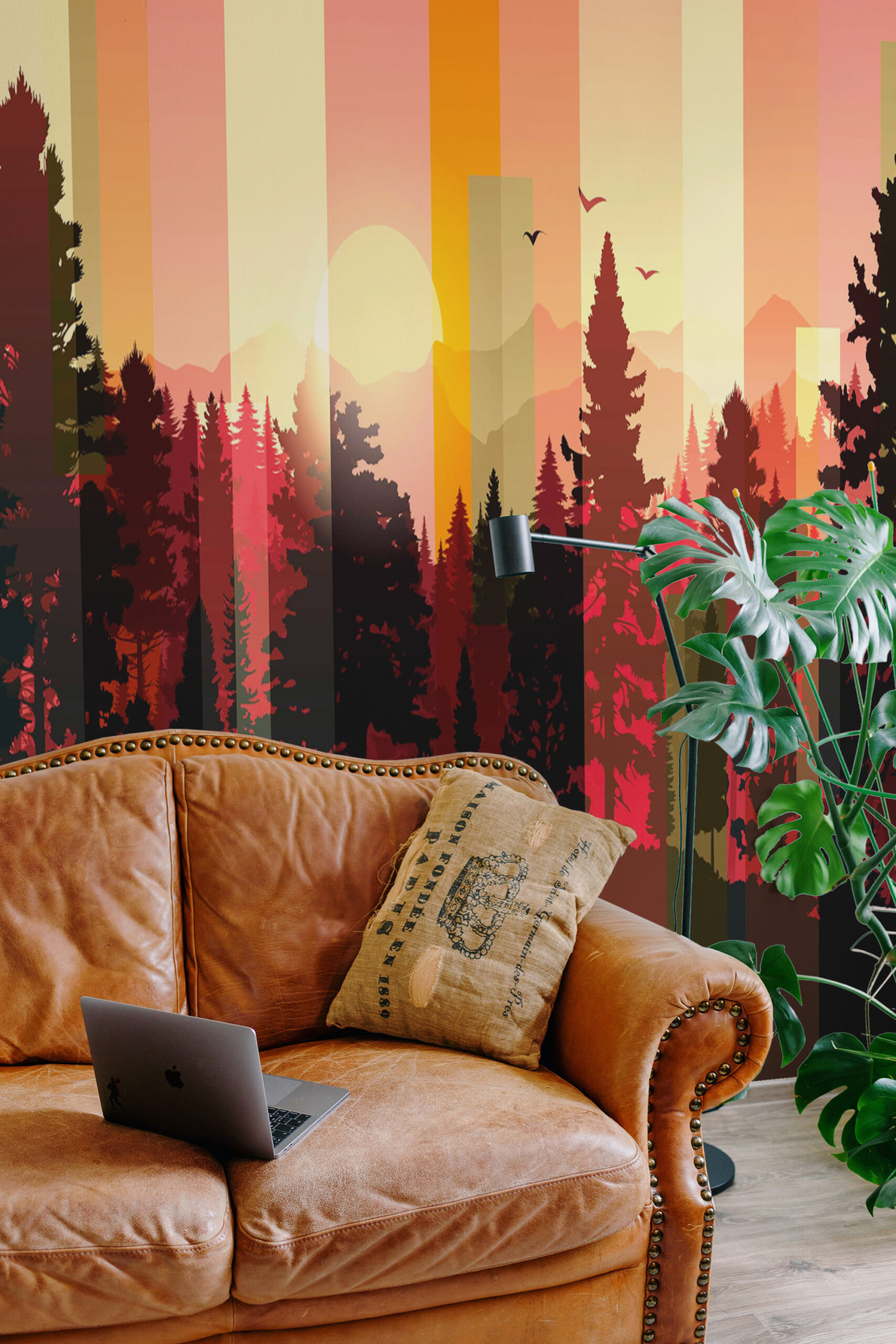 Striped Forest Sunset spans the living room wall as a wall mural, with striped sky, sun, and dark pine silhouettes.