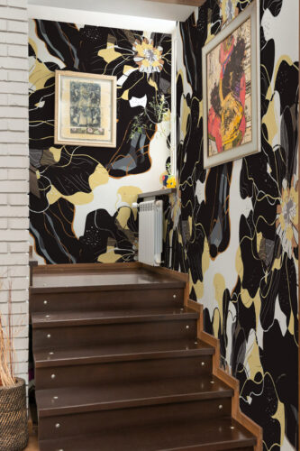 Modern Dark Floral wall mural wrapping a stairwell, with bold black and gold flowers covering the walls around the steps.