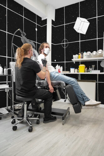 Cosmic Grid Night Sky covers the studio walls as a wall mural, with white grid lines and star-speckled black panels.