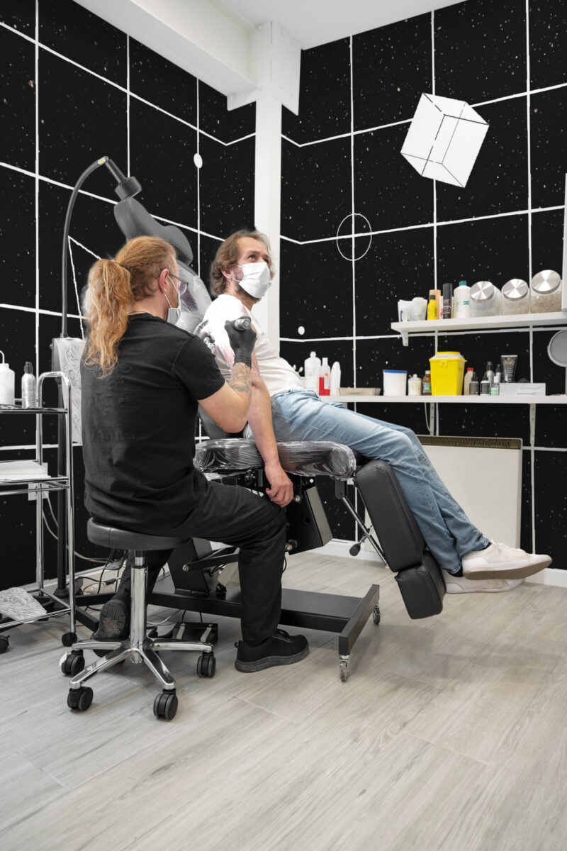 Cosmic Grid Night Sky covers the studio walls as a wall mural, with white grid lines and star-speckled black panels.