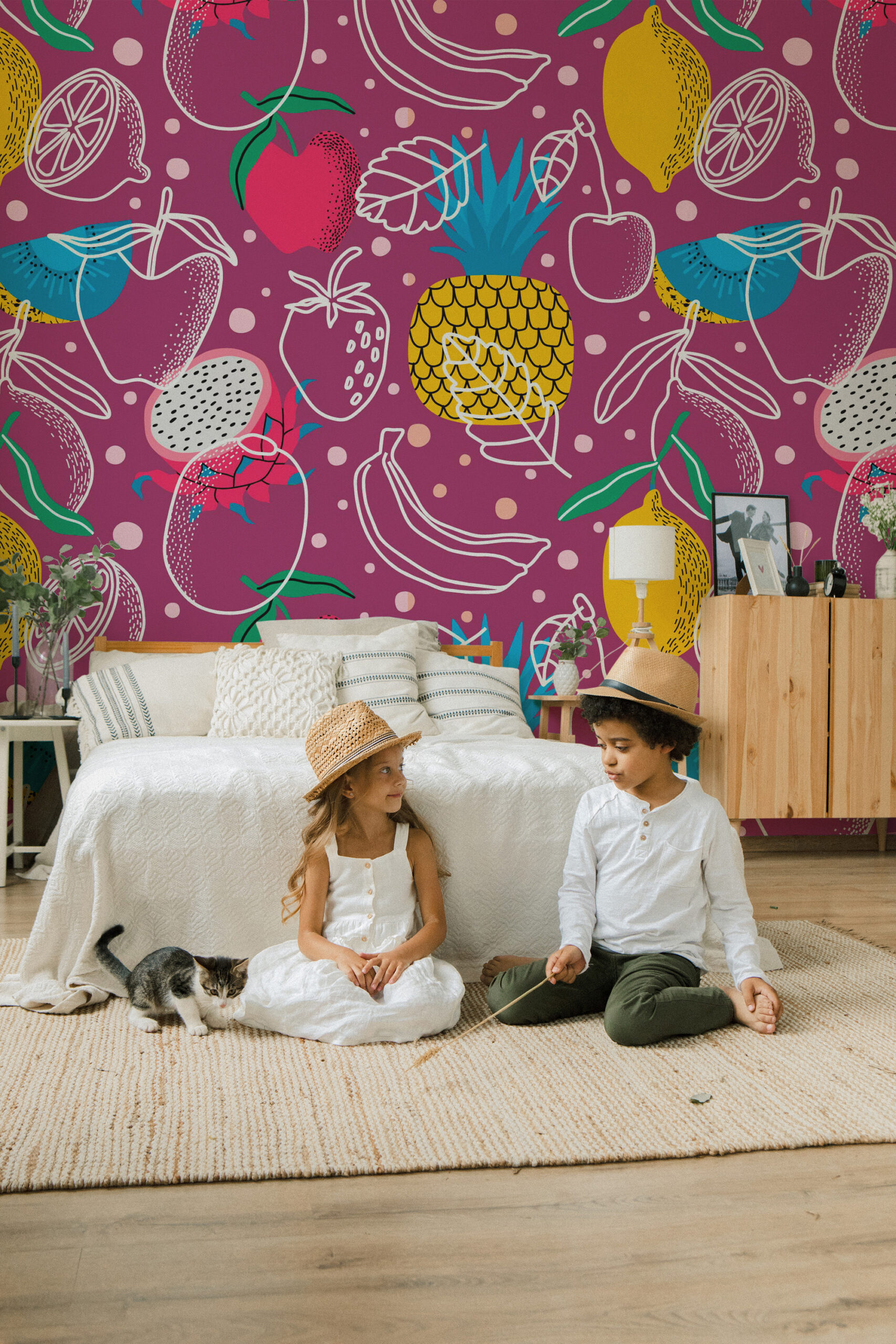 Tropical Fruit Doodles removable wall mural fills a bedroom accent wall with playful fruit sketches and polka dots on a magenta background.