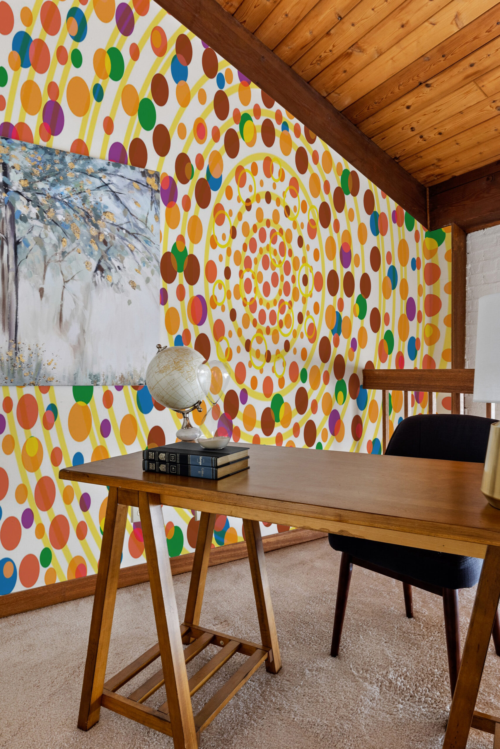 Yellow Dot Vortex covers the accent wall as a wall mural with spiraling yellow rings and multicolor dots in a home office.