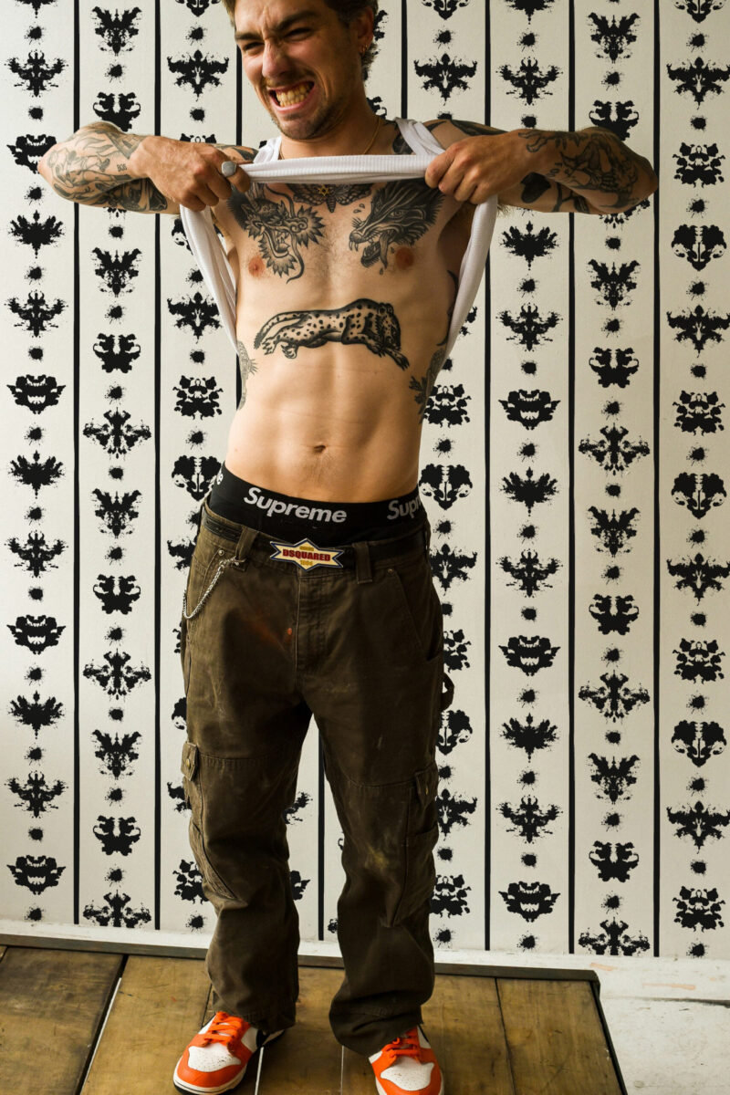 Rorschach Ink Stripes shows black inkblot shapes in vertical stripes on an off-white wall, shown as peel and stick wallpaper.