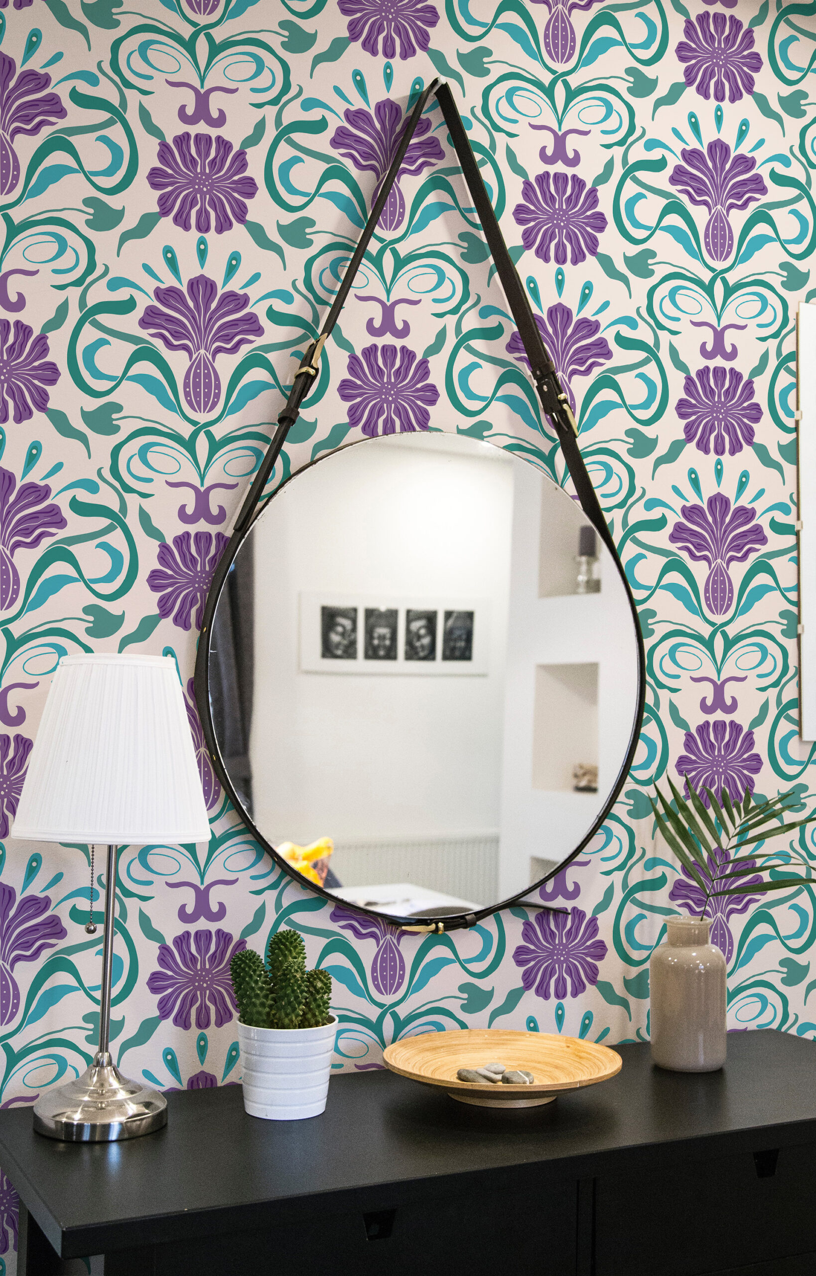 Art Nouveau Purple Floral pre-pasted wallpaper with teal vines and purple blooms behind a round hanging mirror.
