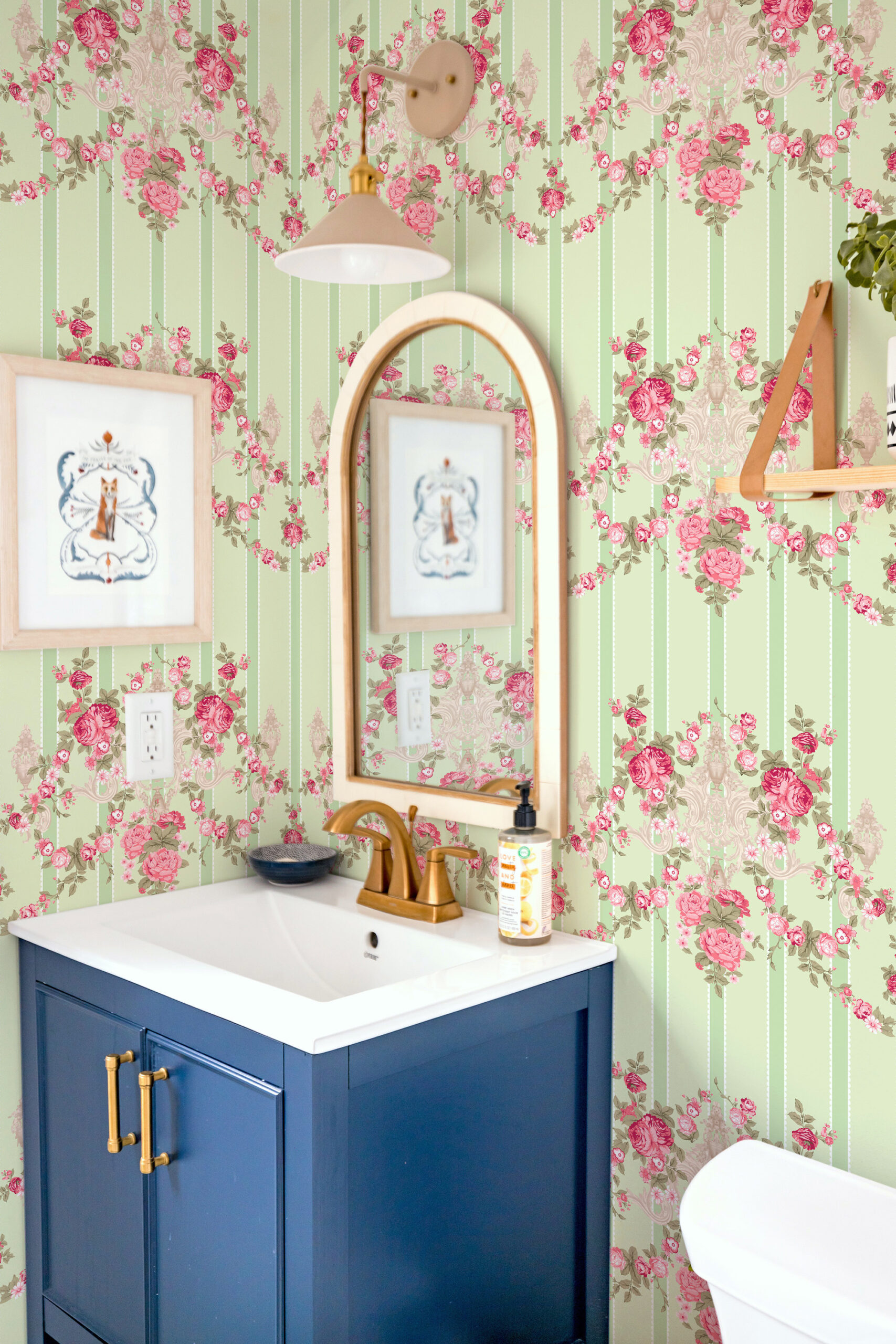 Vintage Floral Stripe non-pasted wallpaper in a bathroom, with pink rose garlands and soft green pinstripes.