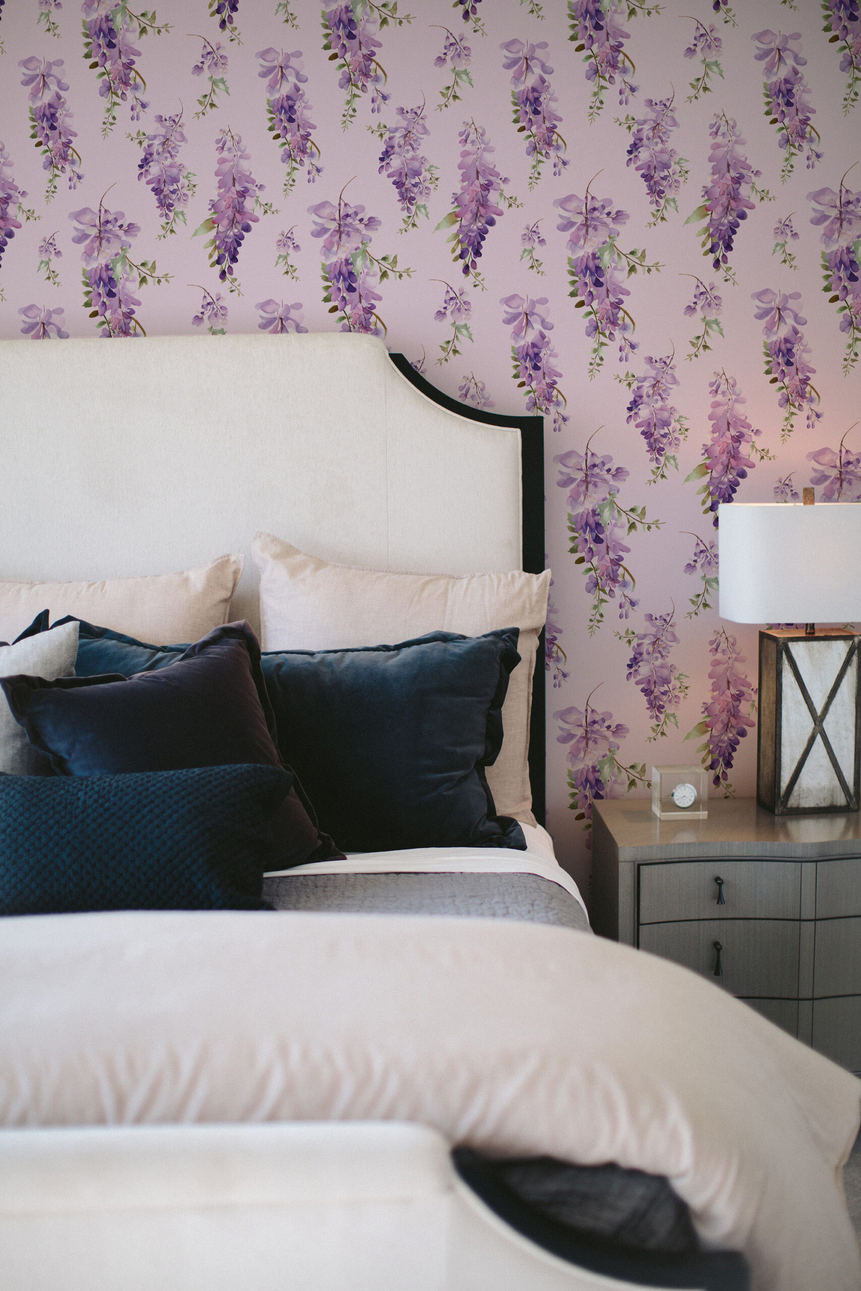 Delicate Purple Wisteria pre-pasted wallpaper with trailing lavender blooms on a pale lilac wall behind the bed.
