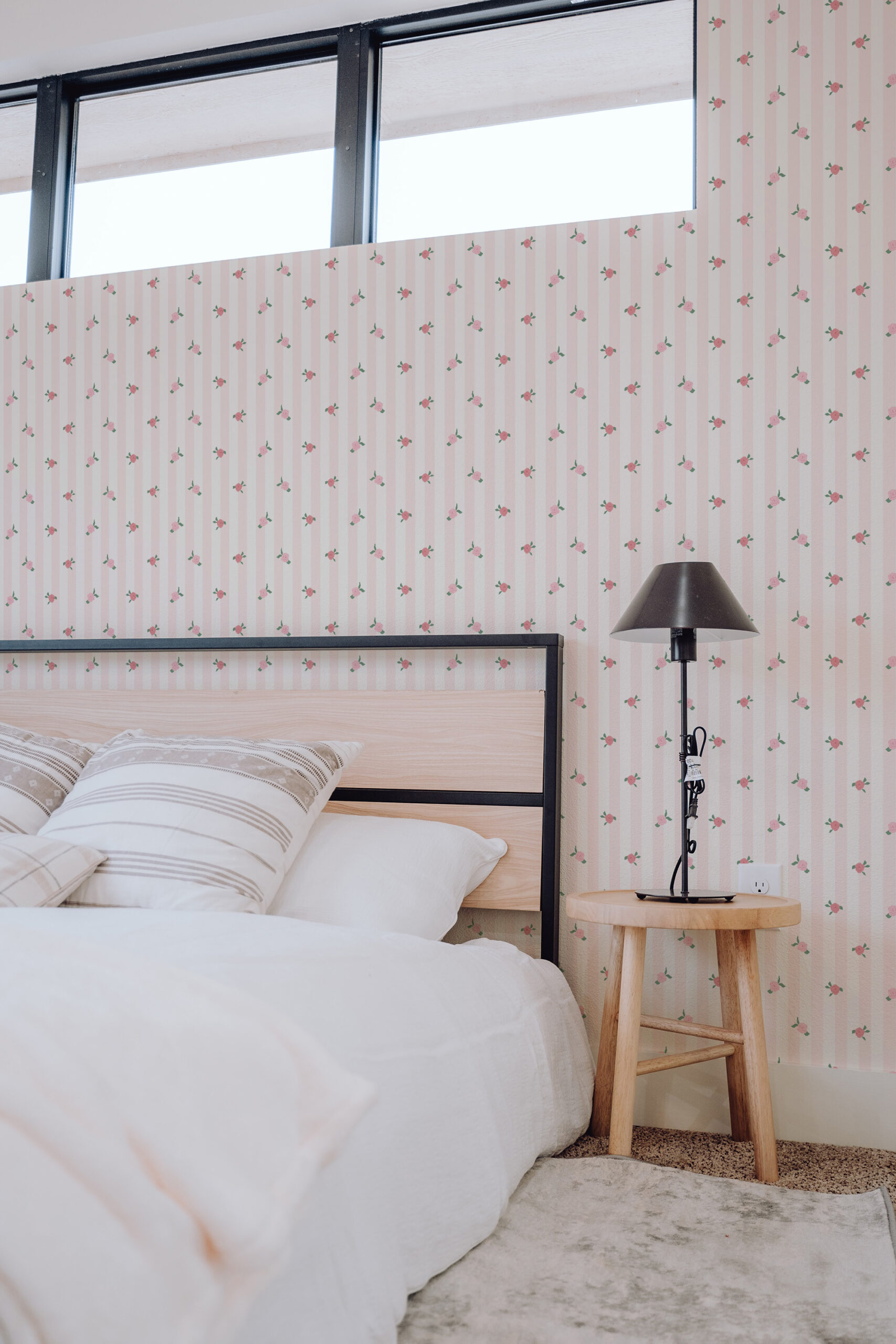 Vintage Pink Rose Stripe self-adhesive wallpaper with soft pink vertical stripes and tiny rosebuds on a bedroom wall.