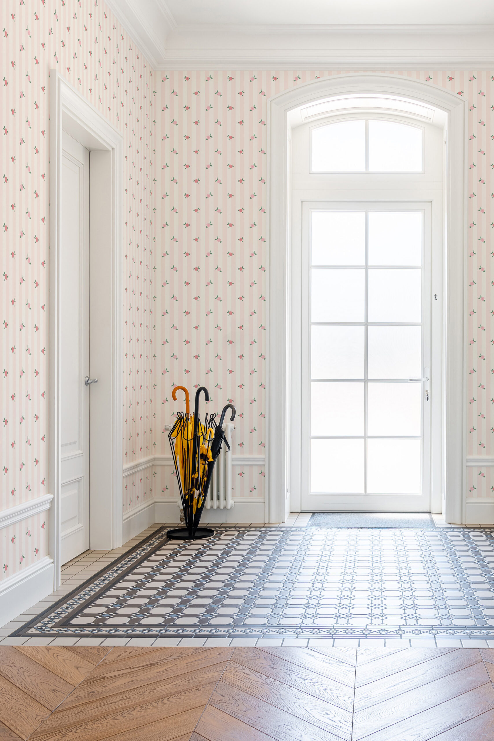 Vintage Pink Rose Stripe non-pasted wallpaper with soft pink stripes and tiny rosebuds covering an entryway wall.