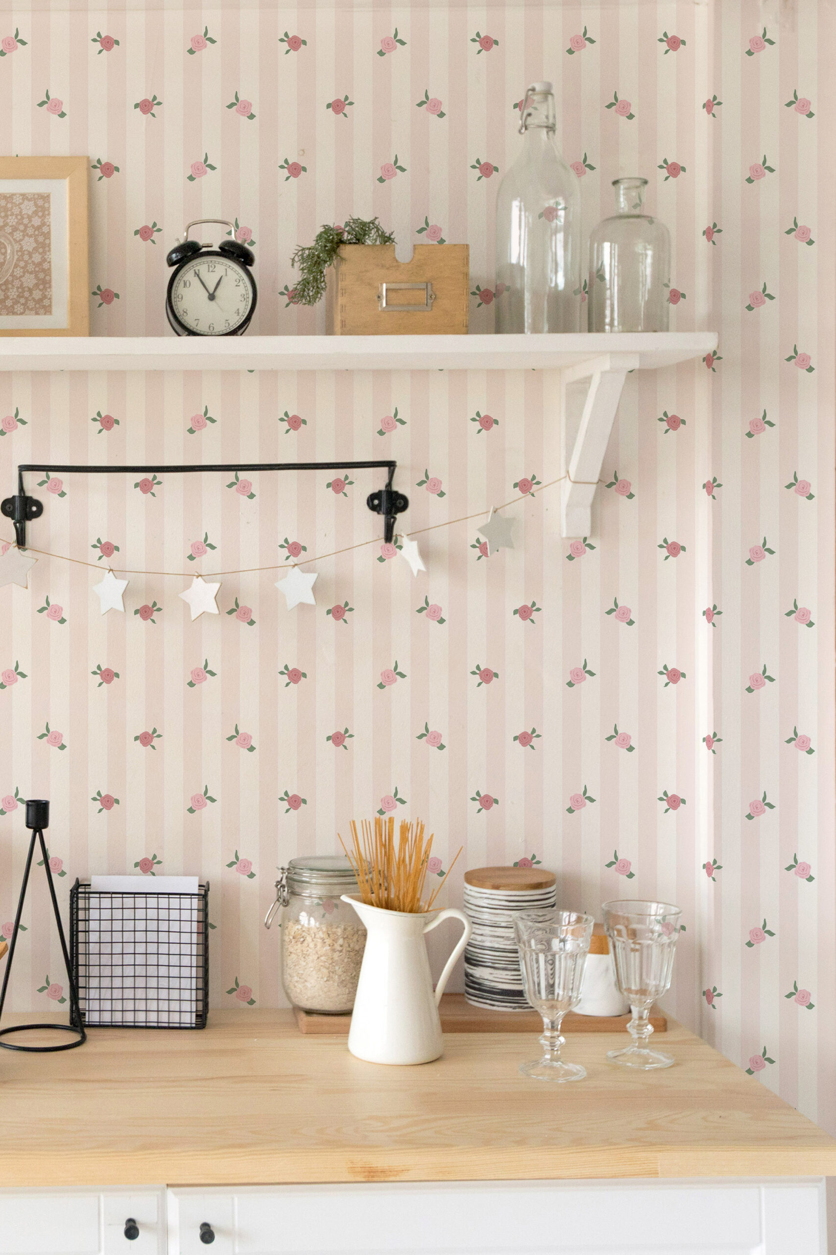 Vintage Pink Rose Stripe peel and stick wallpaper with pale pink stripes and scattered rosebuds behind open kitchen shelves.