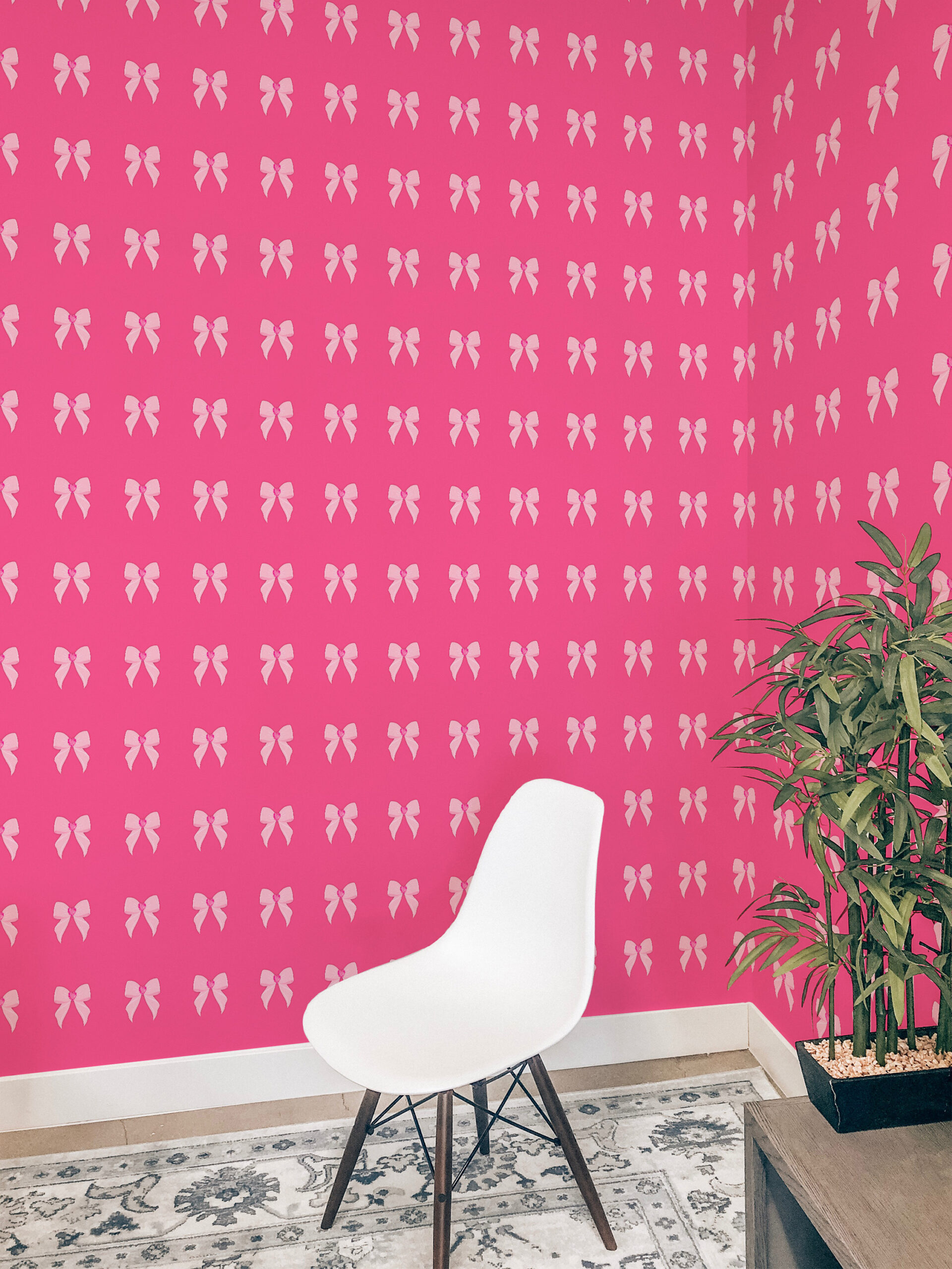 Bold Pink Heart Bows self-adhesive wallpaper with pale pink bow icons across a bright, hot pink wall.