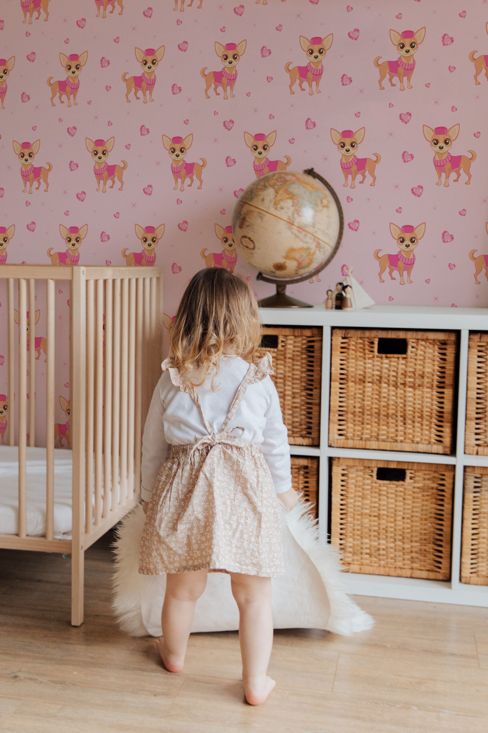 Cute Chihuahua self-adhesive wallpaper with a pink chihuahua and heart pattern across a nursery wall behind the crib.