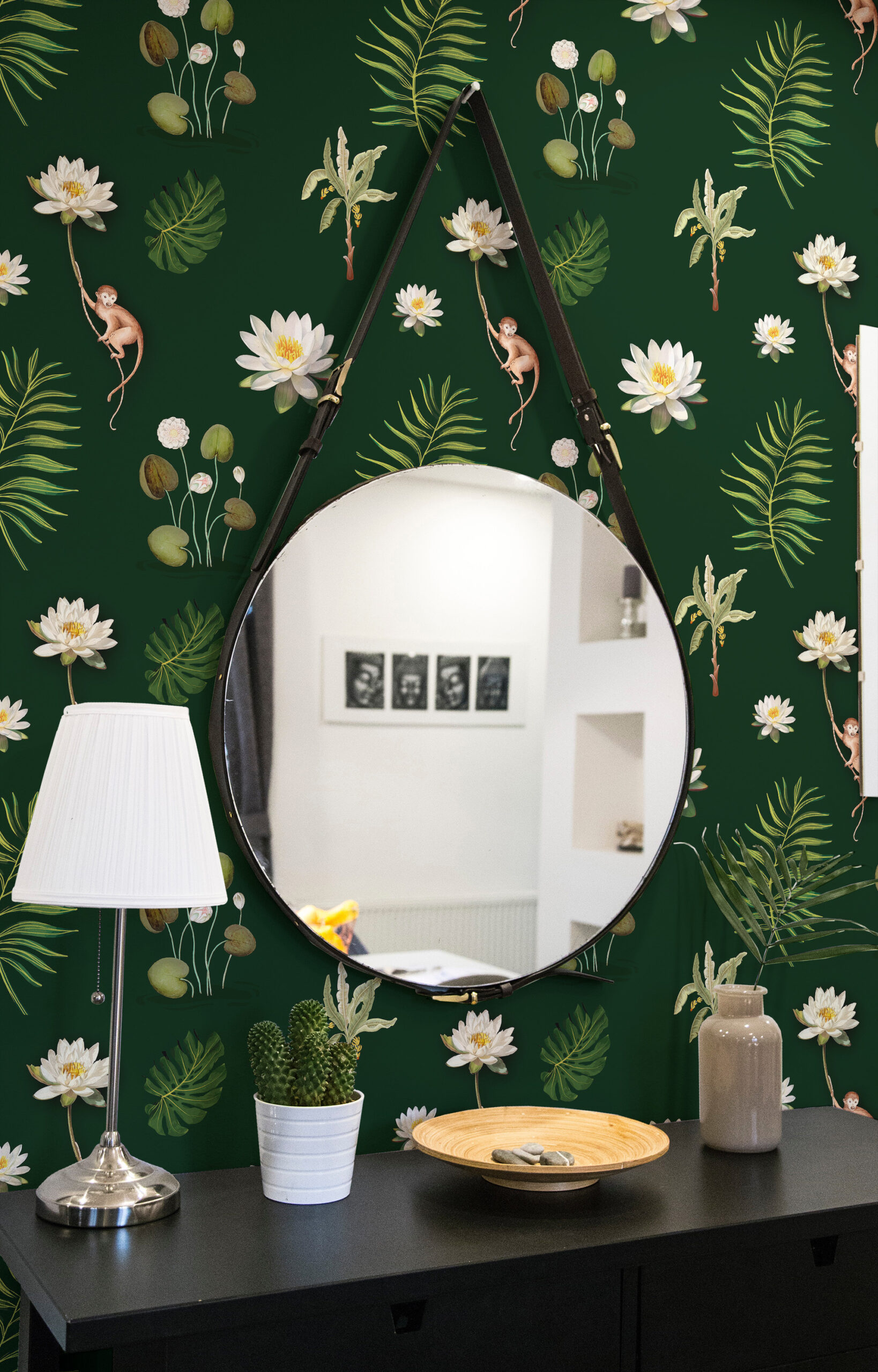 Monkey and White Lotus peel-and-stick wallpaper with white water lilies, tropical leaves, and small monkeys on a deep green wall.