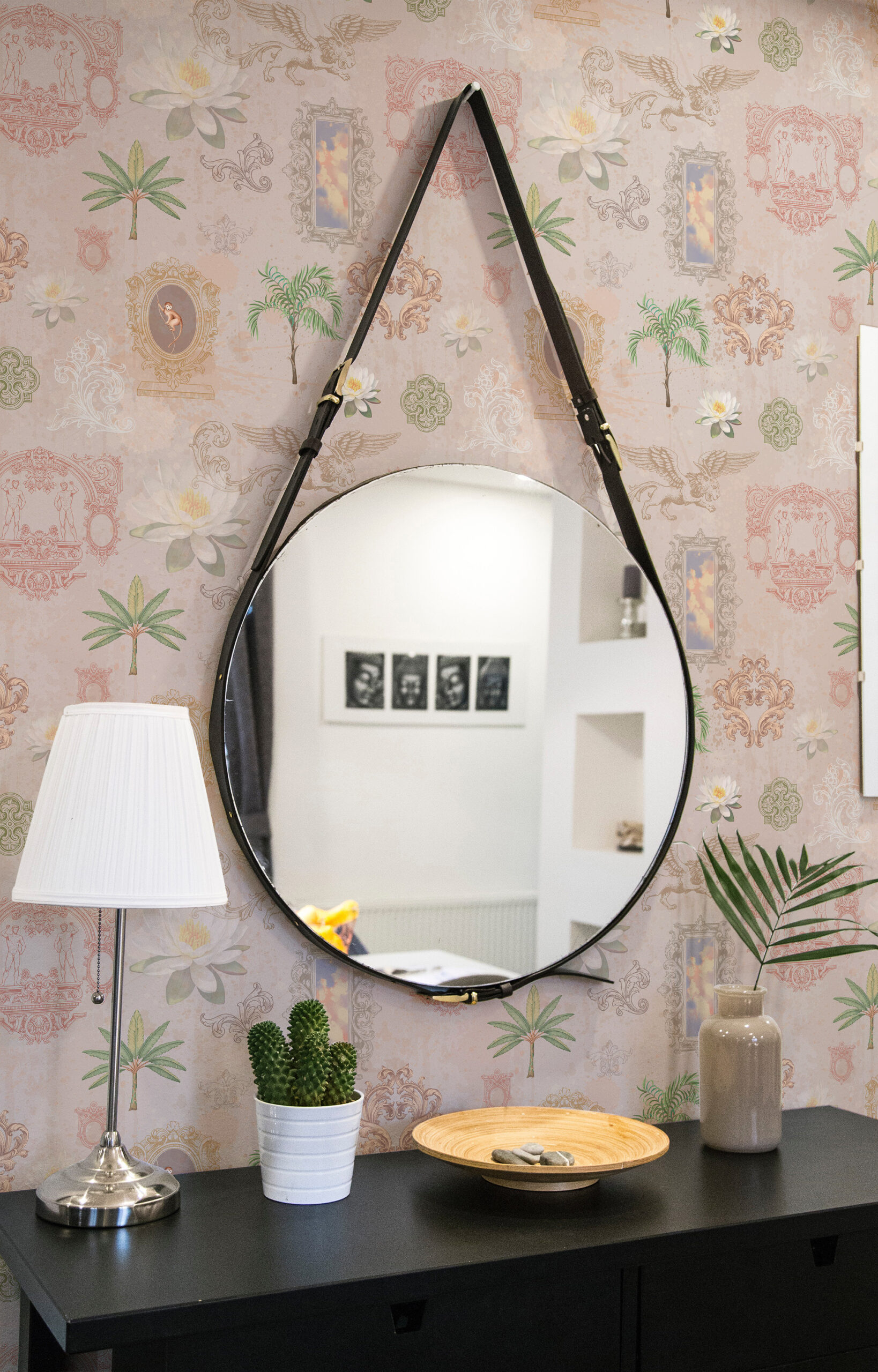 Whimsical Beige Lotus non-pasted wallpaper with lotus flowers, framed scenes, and birds behind a round hanging mirror.