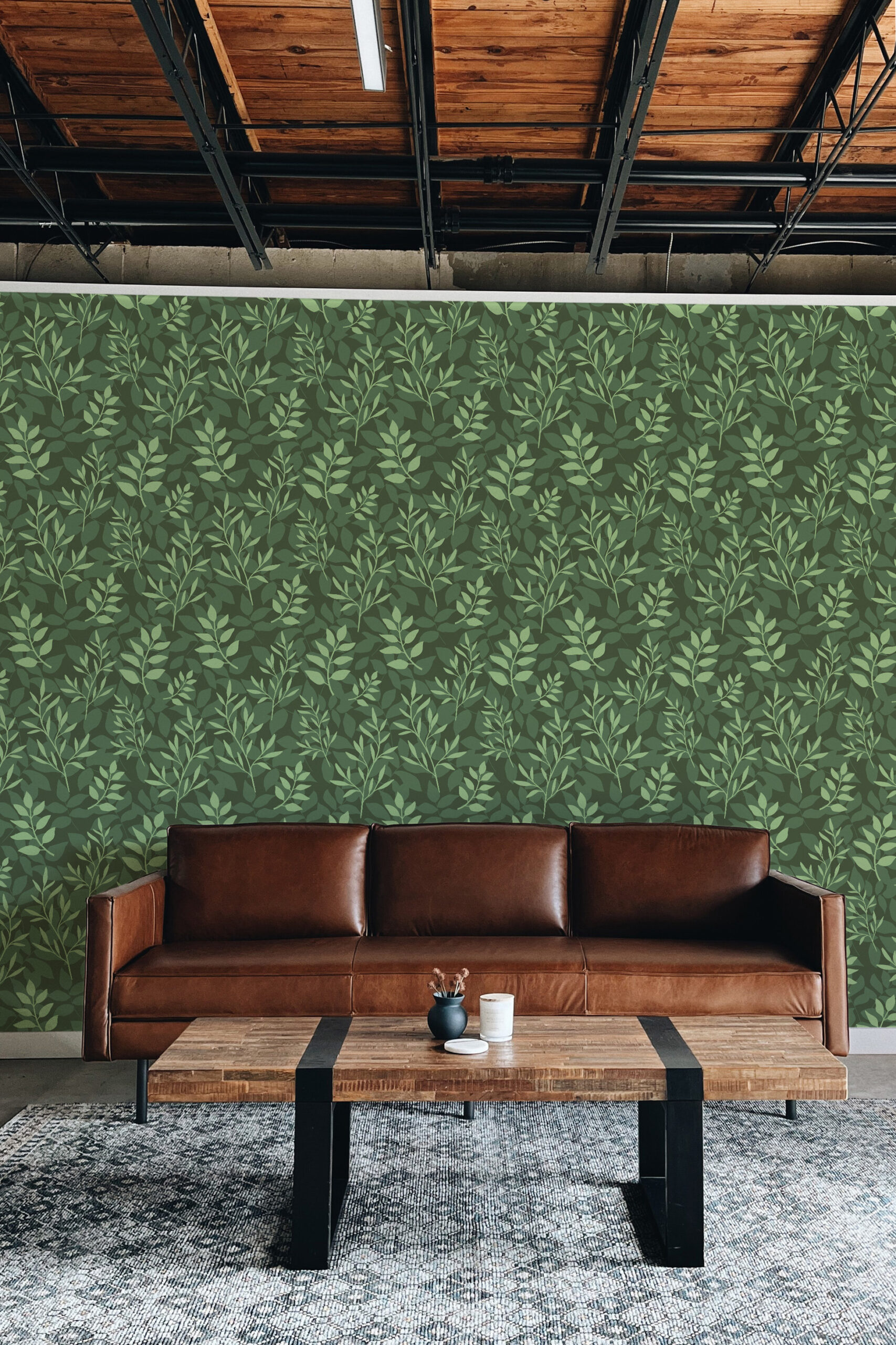 Dense Green Leaf non-pasted wallpaper covering the wall behind a brown leather sofa with a light green vine pattern.