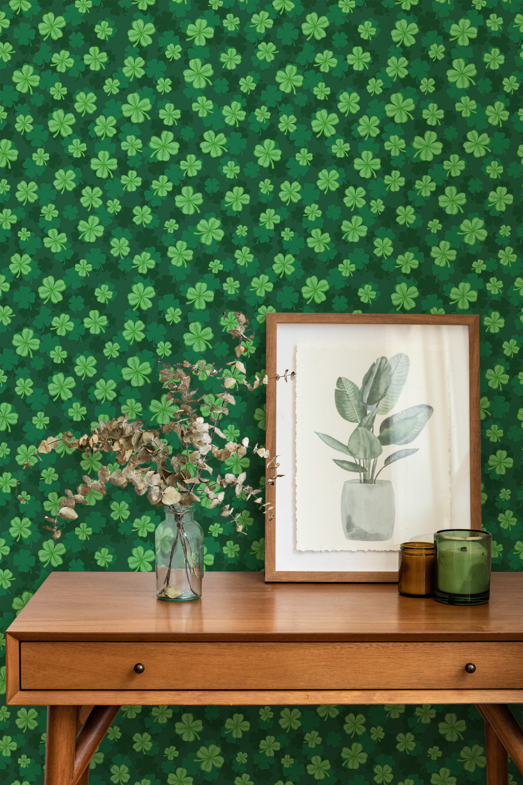Four Leaf Clover non-pasted wallpaper with scattered light green clovers on a deep green wall behind a console table.