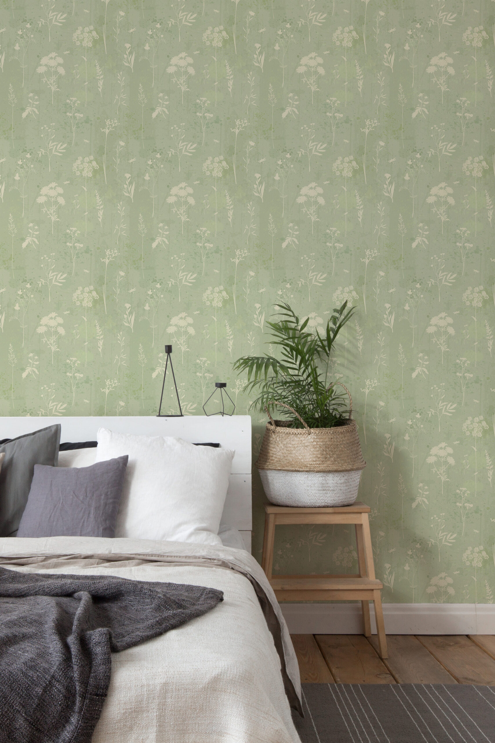 Delicate Sage Wildflower self-adhesive wallpaper with soft white wildflower stems on a sage green wall in a bedroom.