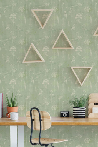 Delicate Sage Wildflower peel and stick wallpaper with soft white wildflowers behind a desk and geometric triangle shelves.