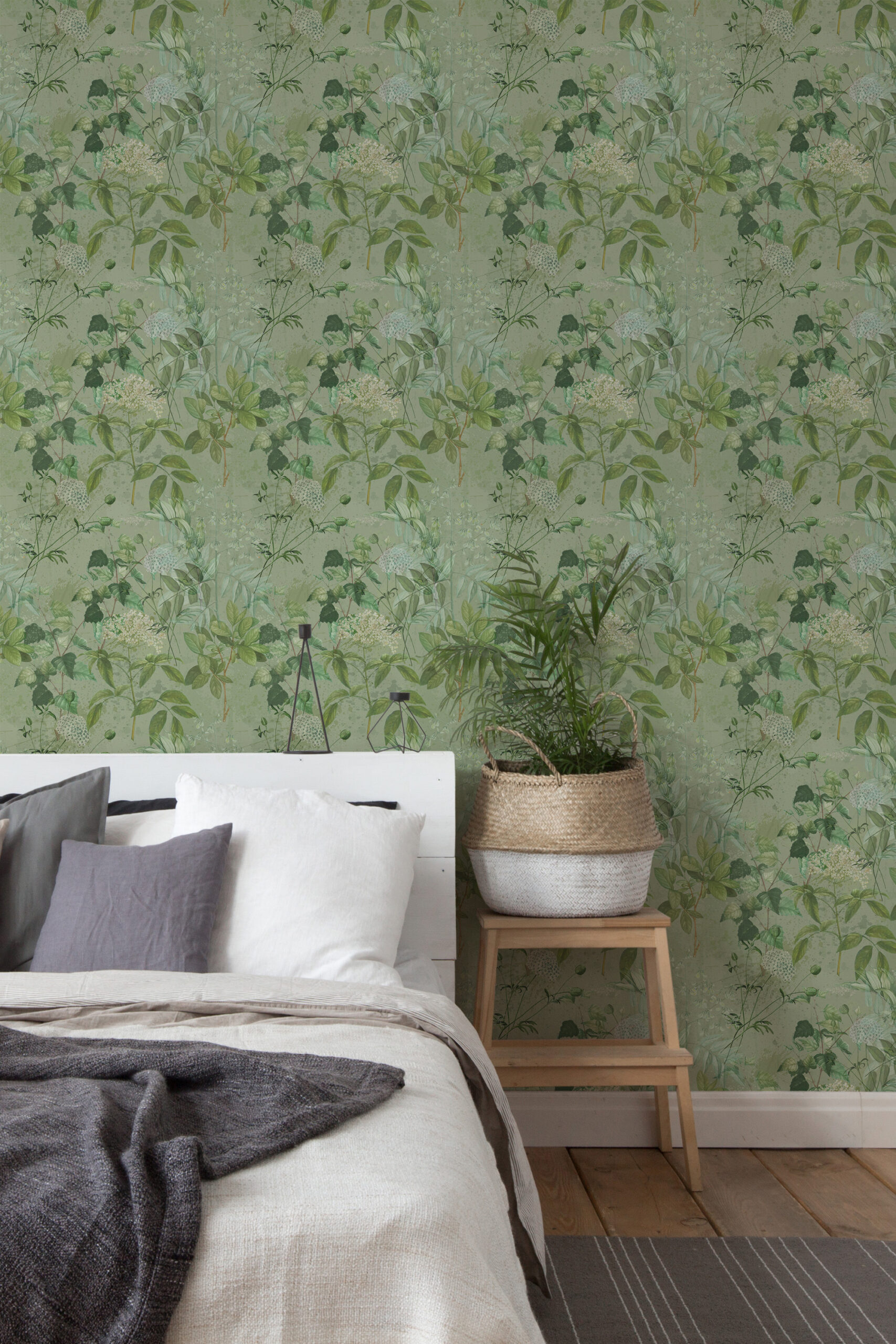 Dreamy Sage Botanical self-adhesive wallpaper on a bedroom wall with soft green leaves and small white blooms.