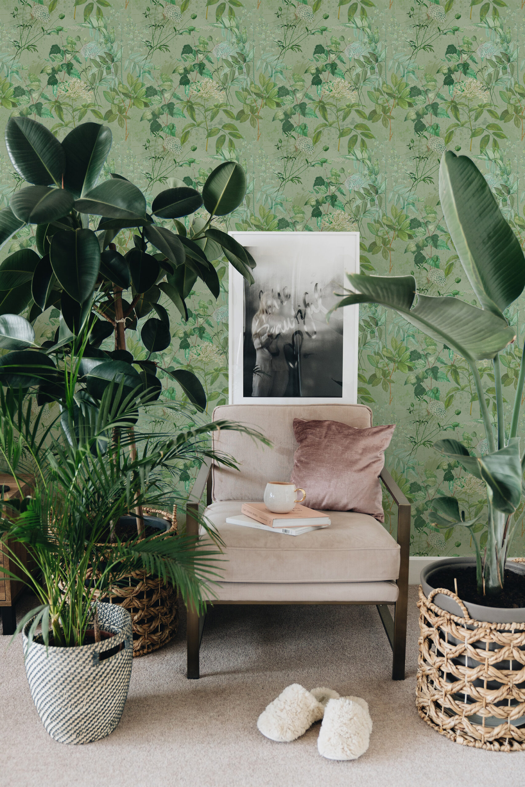 Dreamy Sage Botanical peel and stick wallpaper with soft green vines and tiny blossoms behind a cozy armchair.