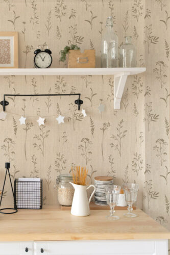Grasscloth Look Wildflower peel and stick wallpaper with soft tan wildflower silhouettes on a textured beige backdrop.