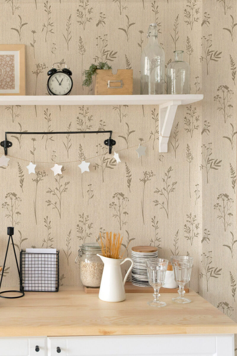 Grasscloth Look Wildflower peel and stick wallpaper with soft tan wildflower silhouettes on a textured beige backdrop.