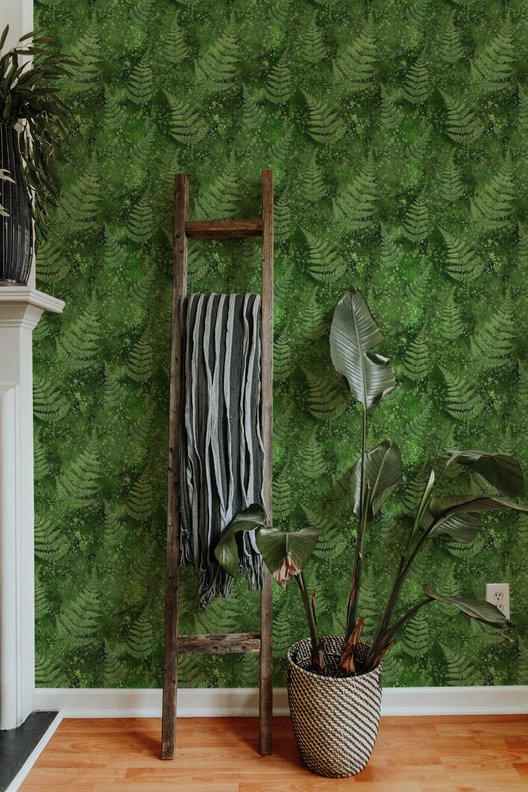 Green Moss and Fern non-pasted wallpaper with layered fern fronds across the wall behind a wooden ladder and potted plant.