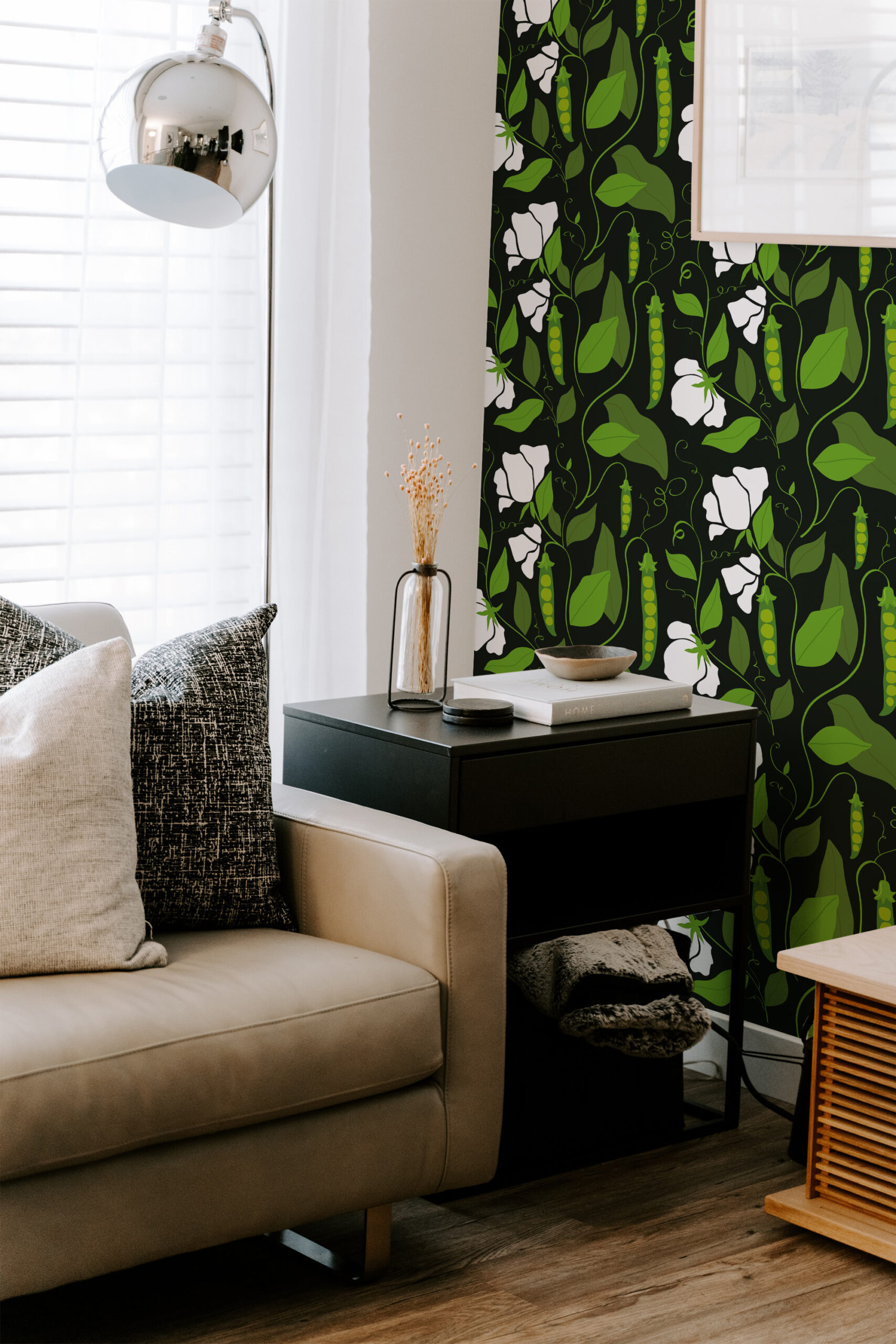 Bold Pea Pod non-pasted wallpaper with green vines, pea pods, and white blooms on a black accent wall.