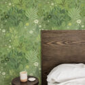 Green Whimsical Wildflowers in peel and stick wallpaper behind a wooden headboard in a bedroom.