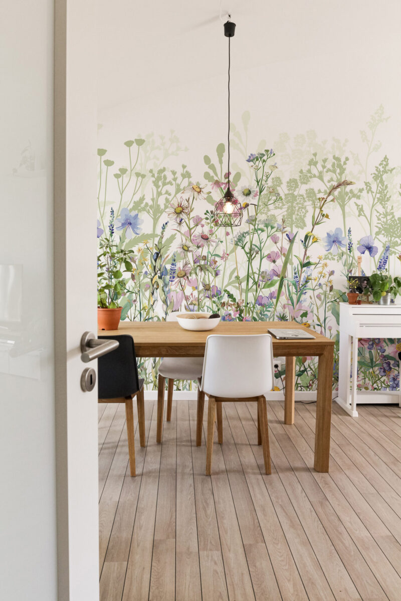 Fresh Garden Wildflowers peel and stick wall mural covering the dining nook wall with watercolor meadow flowers in soft green, pink, and blue.