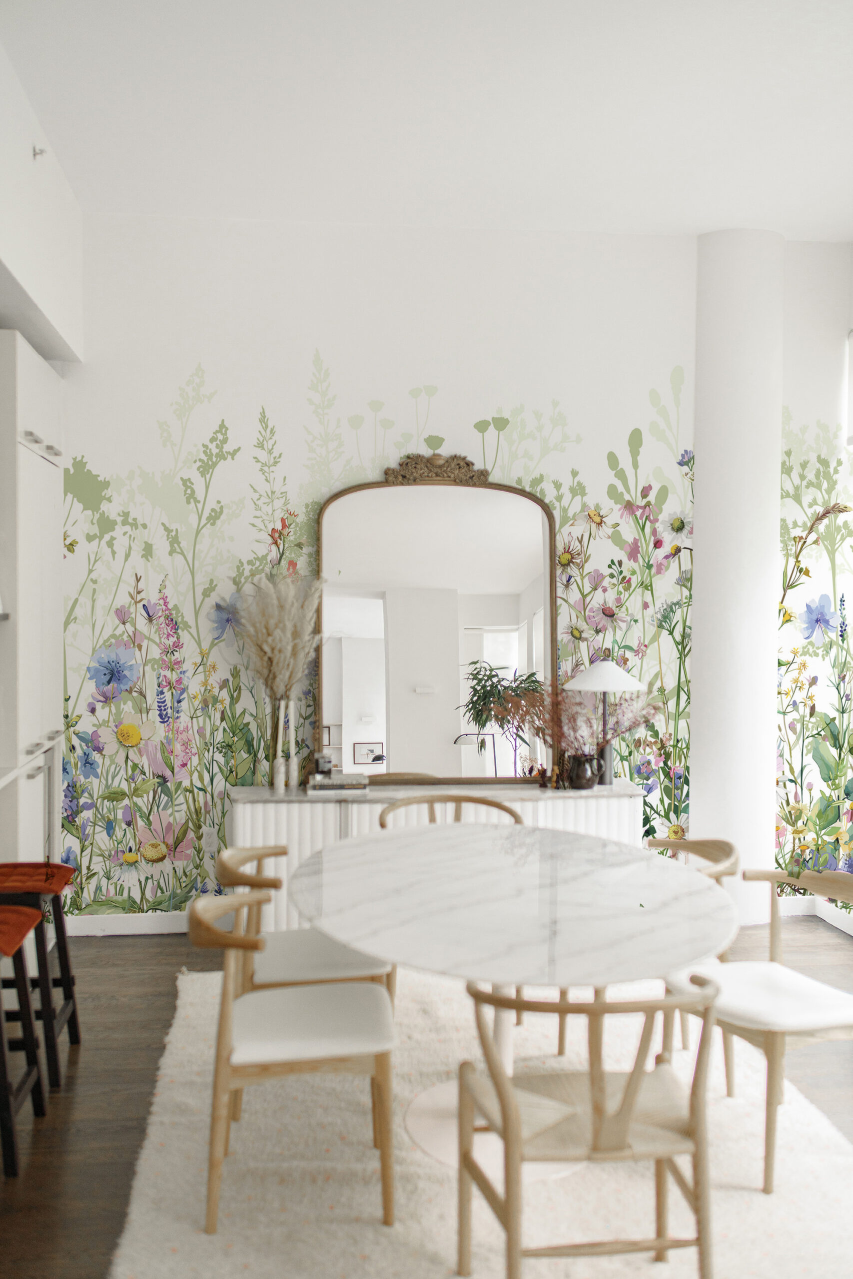 Fresh Garden Wildflowers non-pasted wall mural wrapping a dining room, with watercolor meadow flowers and soft green stems along the walls.