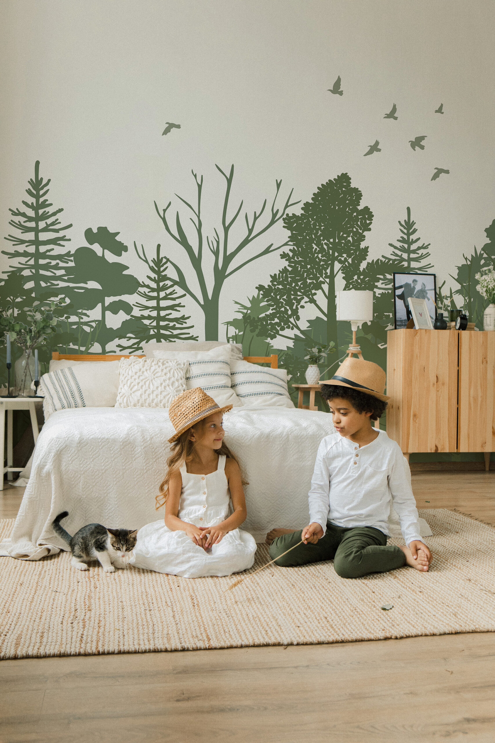 Sage Green Forest Scene pre-pasted wall mural spans a bedroom wall with layered tree silhouettes and small birds overhead.