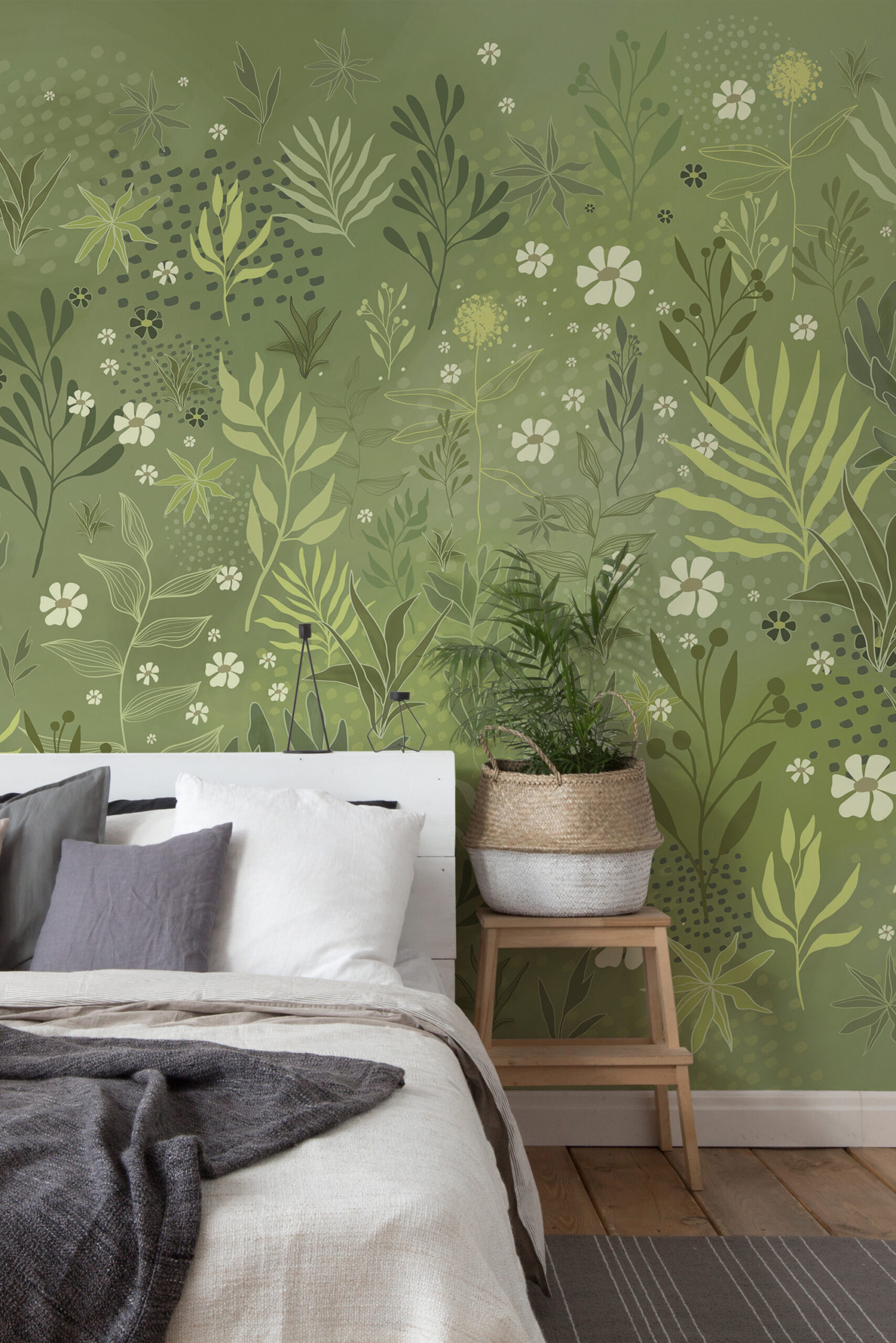 Whimsical Wild Garden pre-pasted Wall Mural with layered green foliage and small white flowers behind a bed in a calm bedroom.