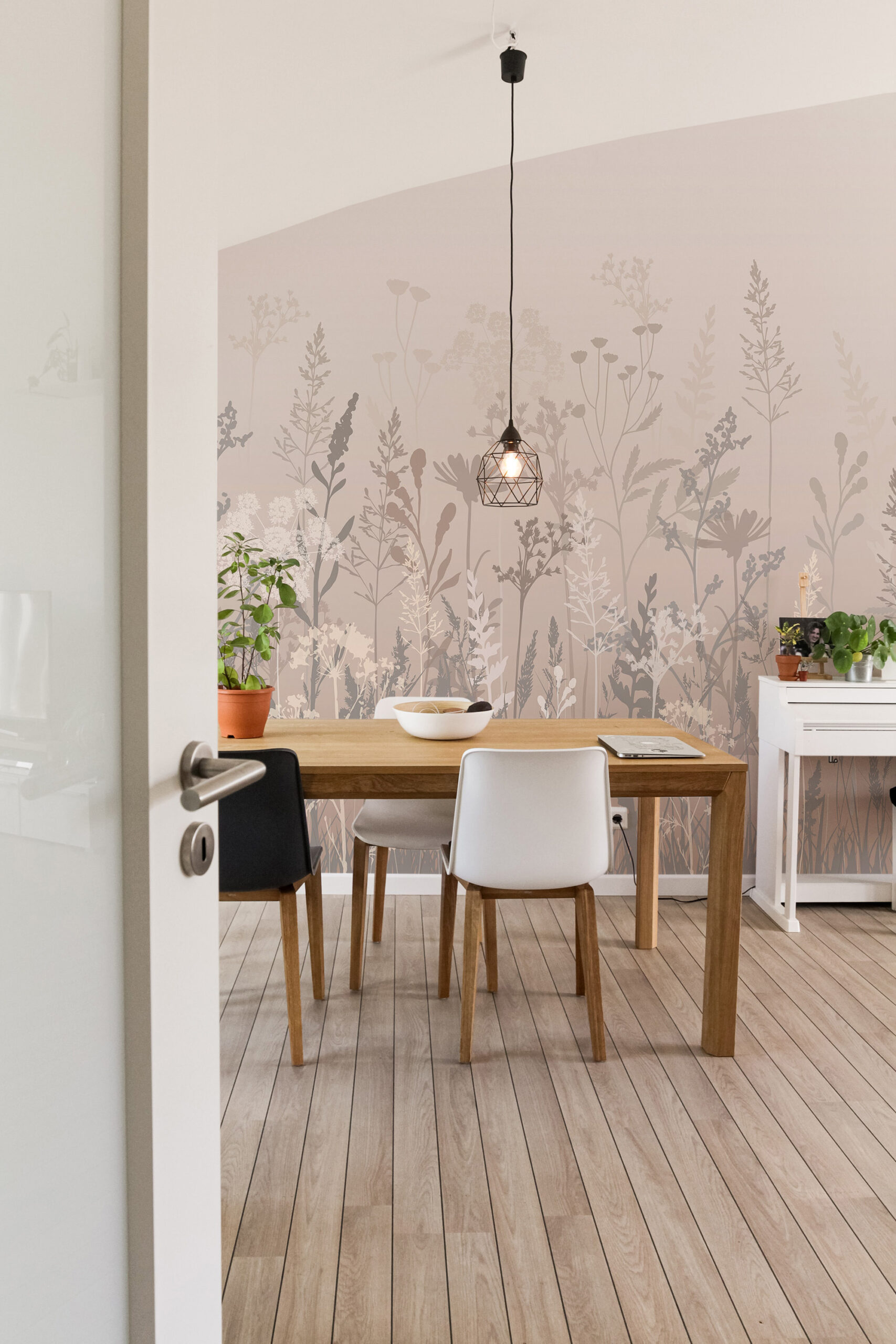 Dreamy Beige Meadow non-pasted wall mural covering the dining room wall with soft beige and gray wildflower silhouettes behind the table.