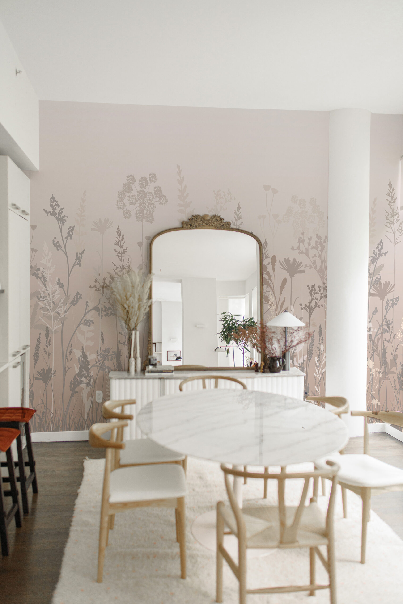 Dreamy Beige Meadow covers a dining room wall as a wall mural with soft beige silhouettes of wildflowers behind a large mirror.