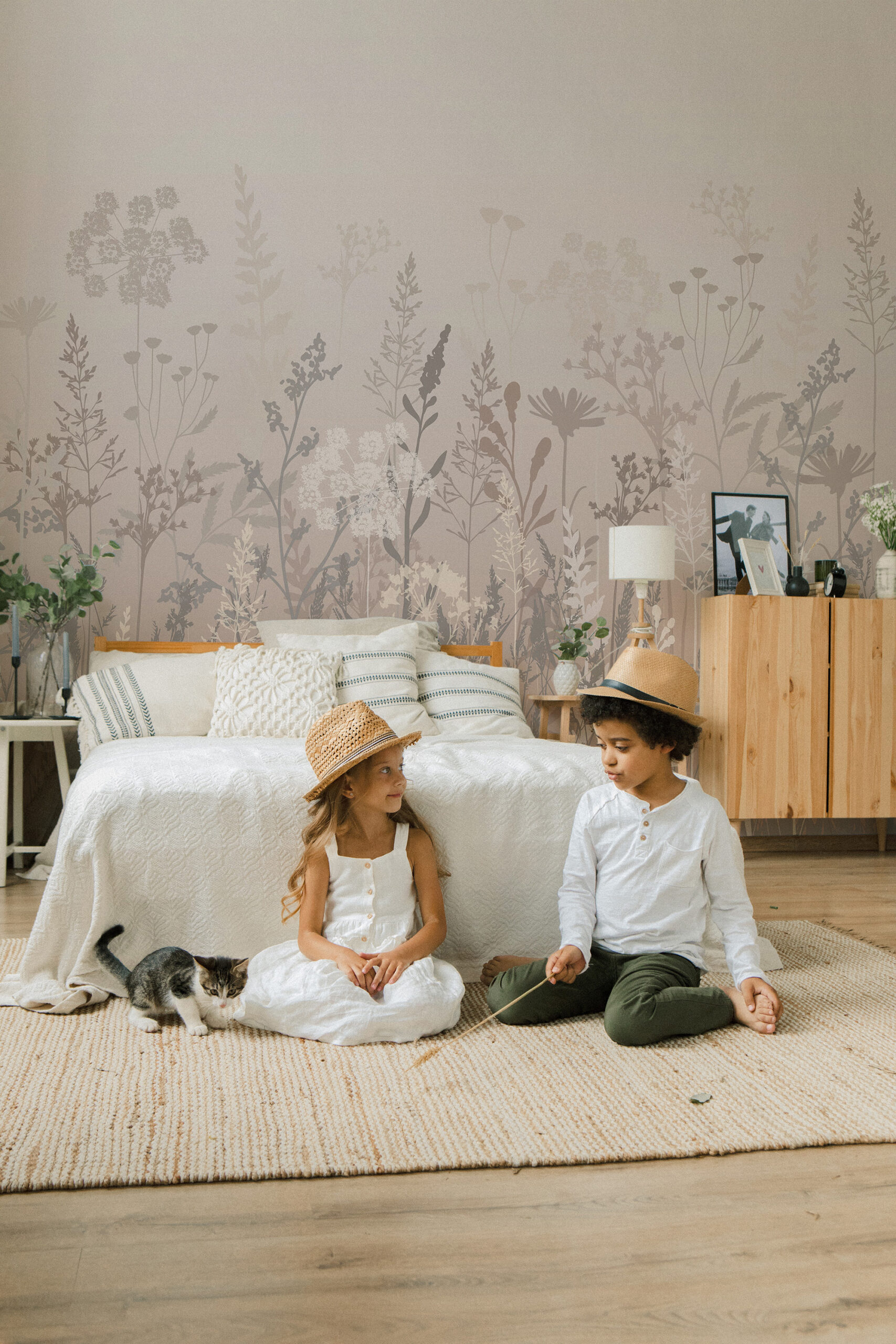 Dreamy Beige Meadow wall mural with soft meadow silhouettes across the full wall behind a bed in a calm bedroom scene.