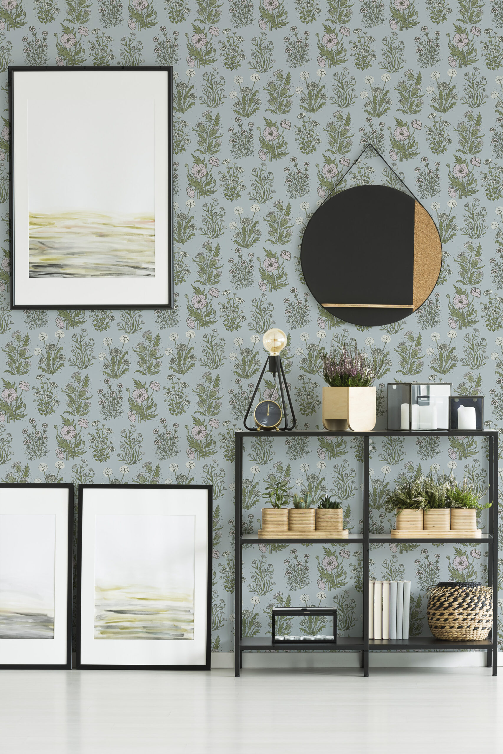 Fine Blue Wildflower peel and stick wallpaper with scattered green stems and small pink blooms on a pale blue wall.