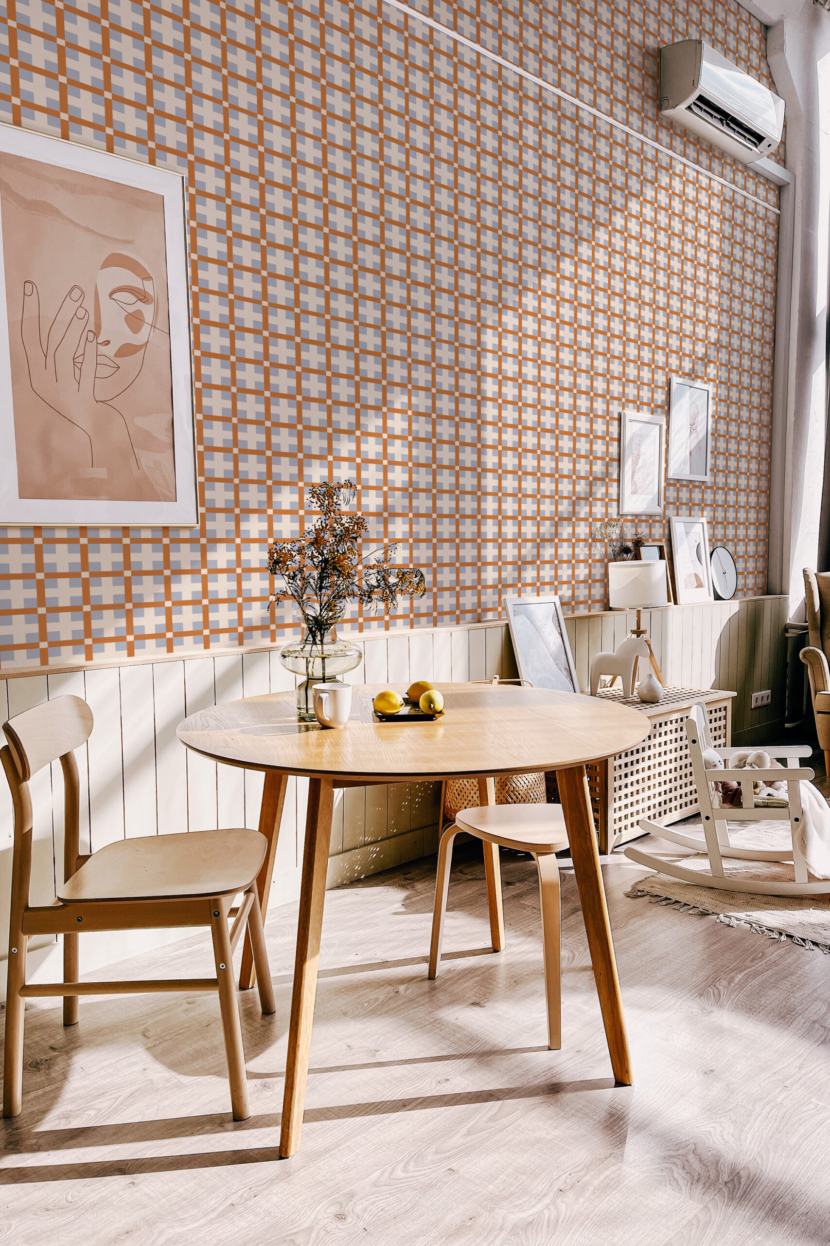 Orange Retro Cross Grid self-adhesive wallpaper covers a dining room wall in an orange and gray crosshatch grid.