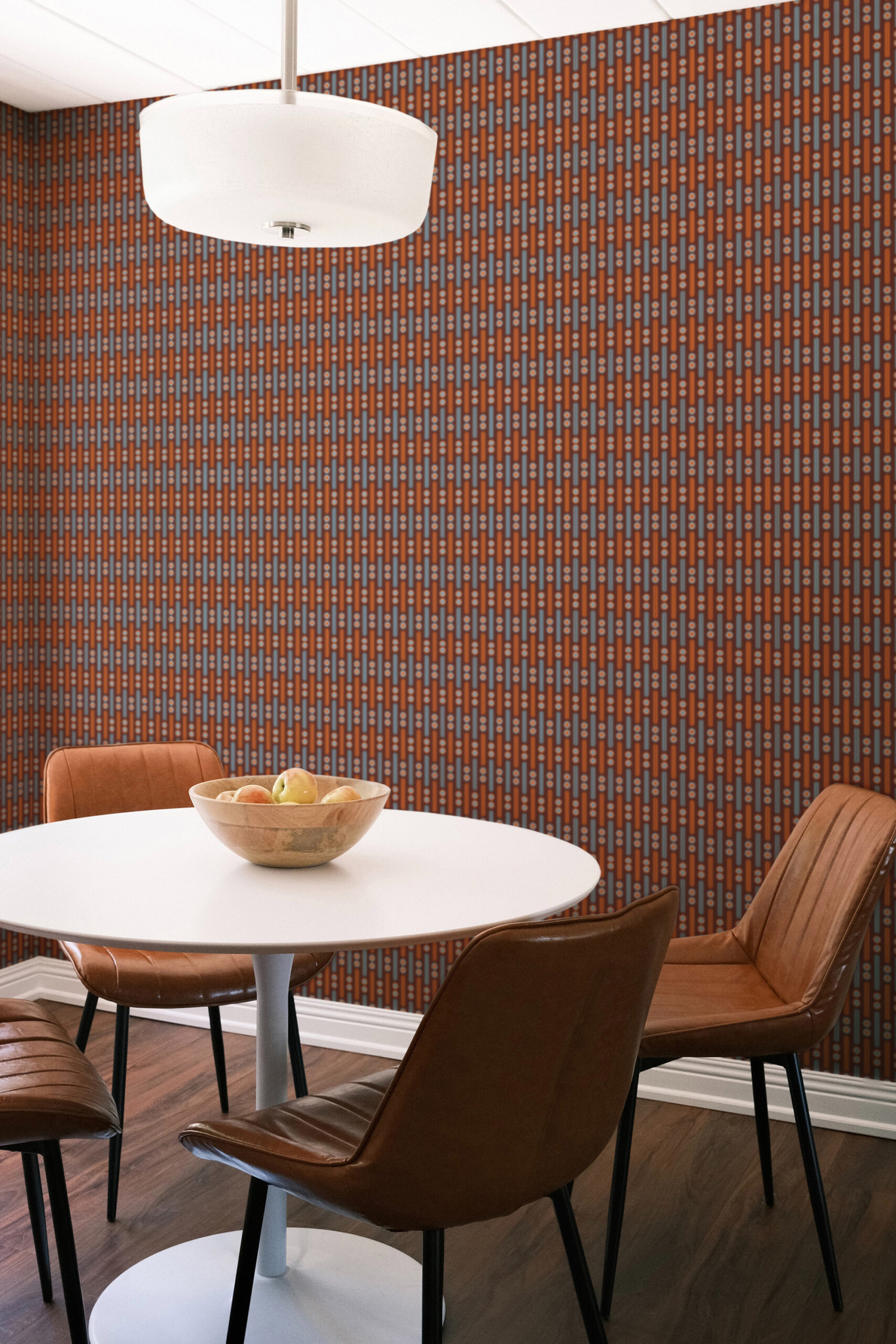 Retro Burgundy Geometric with orange lines and pale blue dots covers a dining nook wall as non-pasted wallpaper.