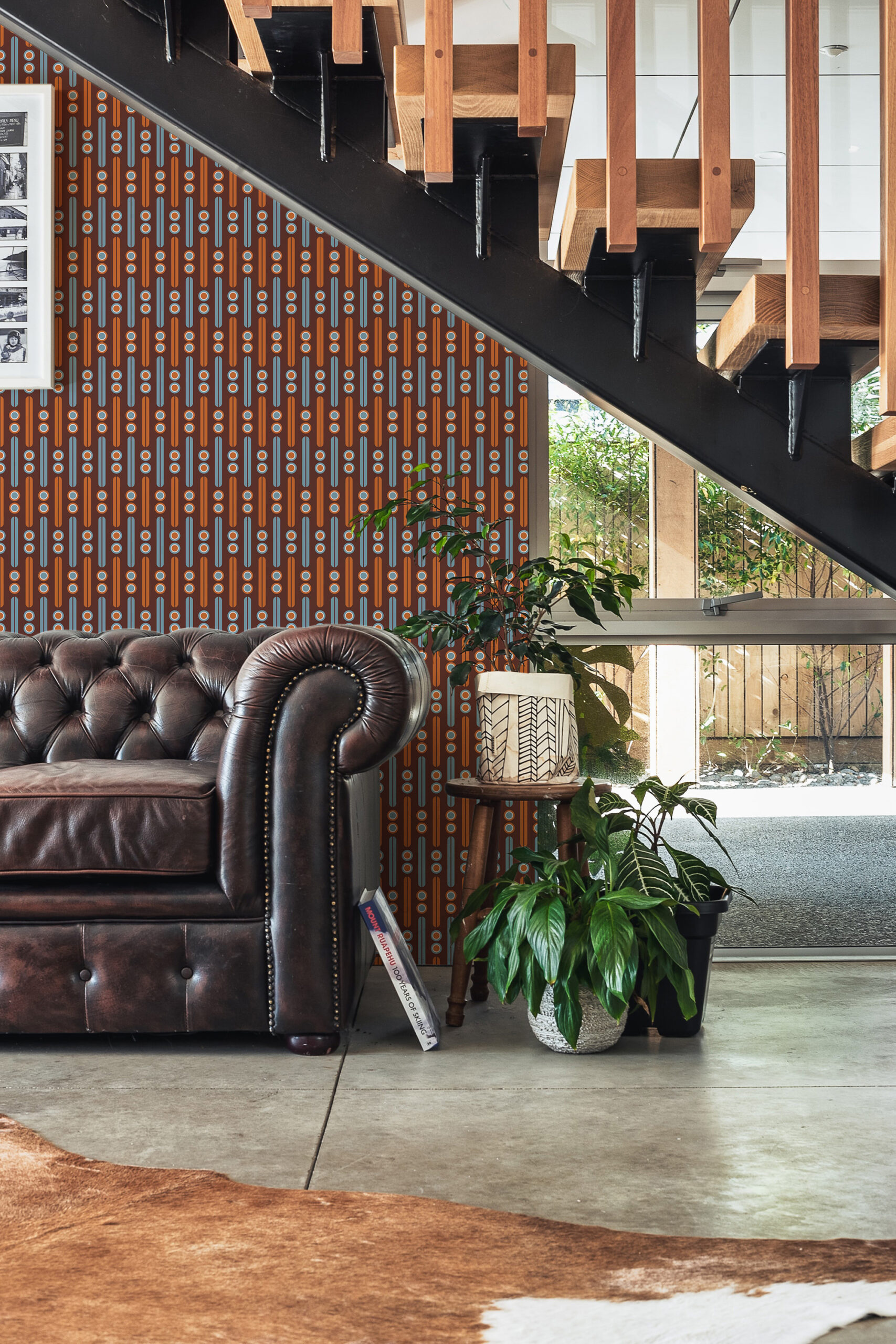 Retro Burgundy Geometric peel and stick wallpaper in a vertical dot-and-stripe pattern on an accent wall under the stairs.