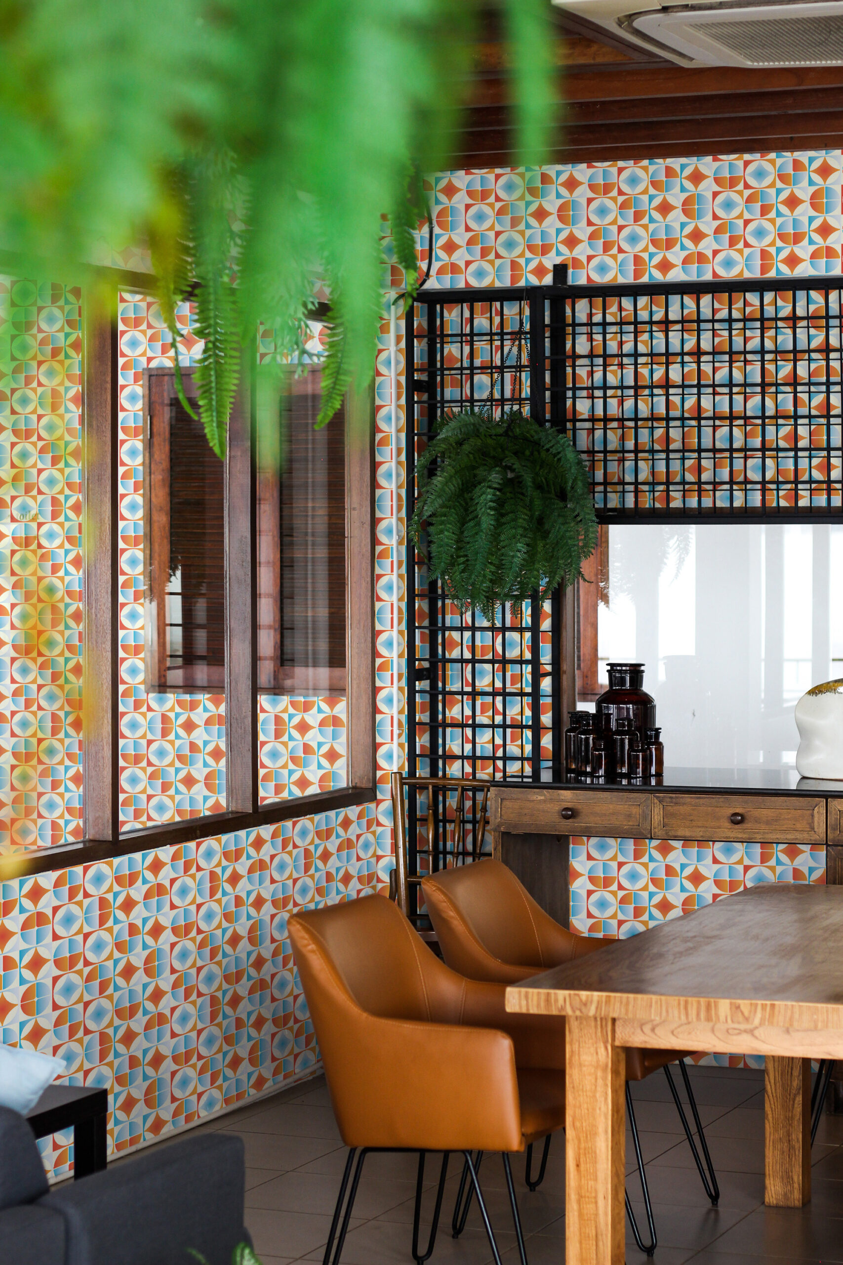 Retro Blue Orange Tile self-adhesive wallpaper with colorful geometric tiles covering the wall around the window.