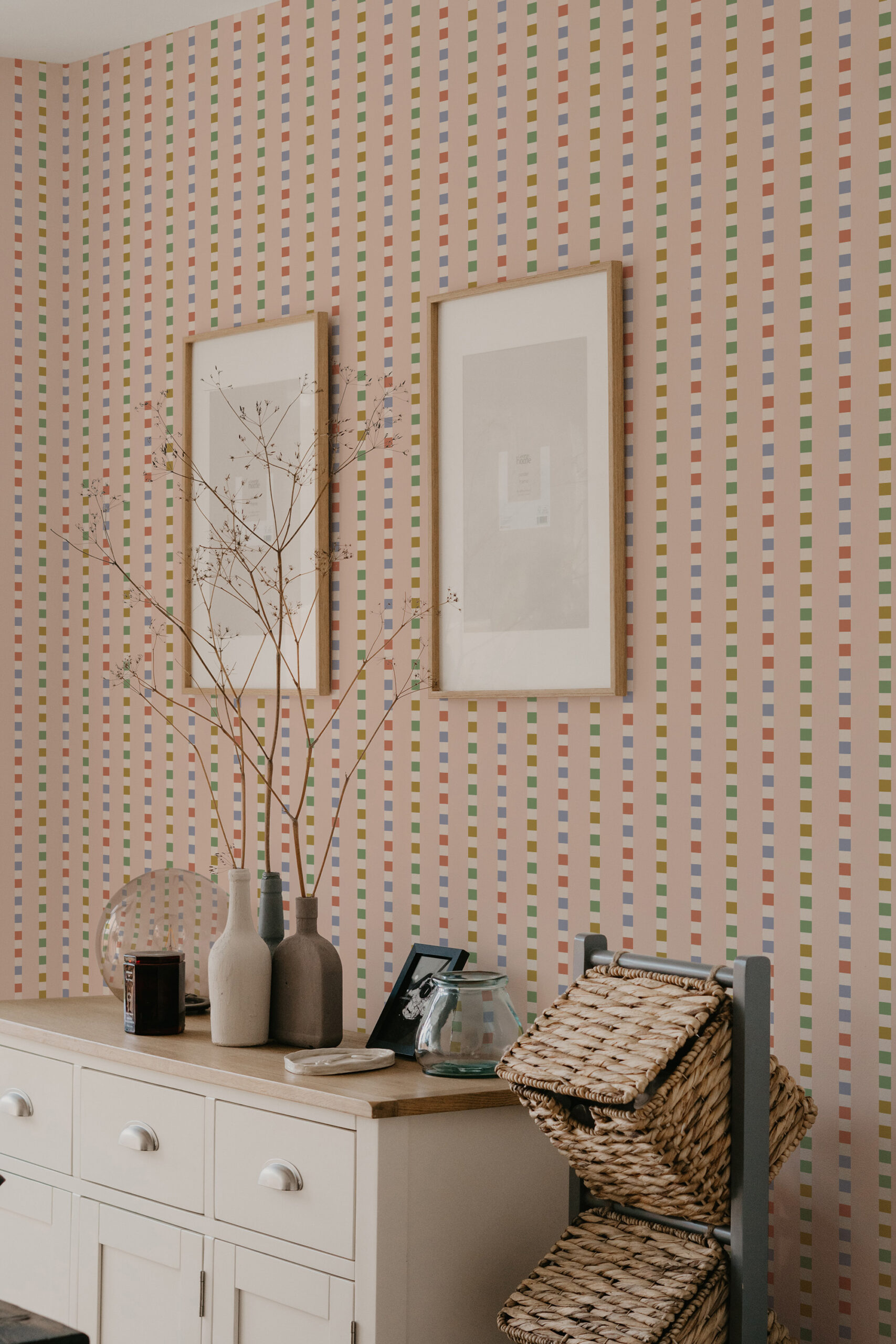 Retro Pink Striped Geometric self-adhesive wallpaper with multicolor vertical dashed stripes behind two framed prints.